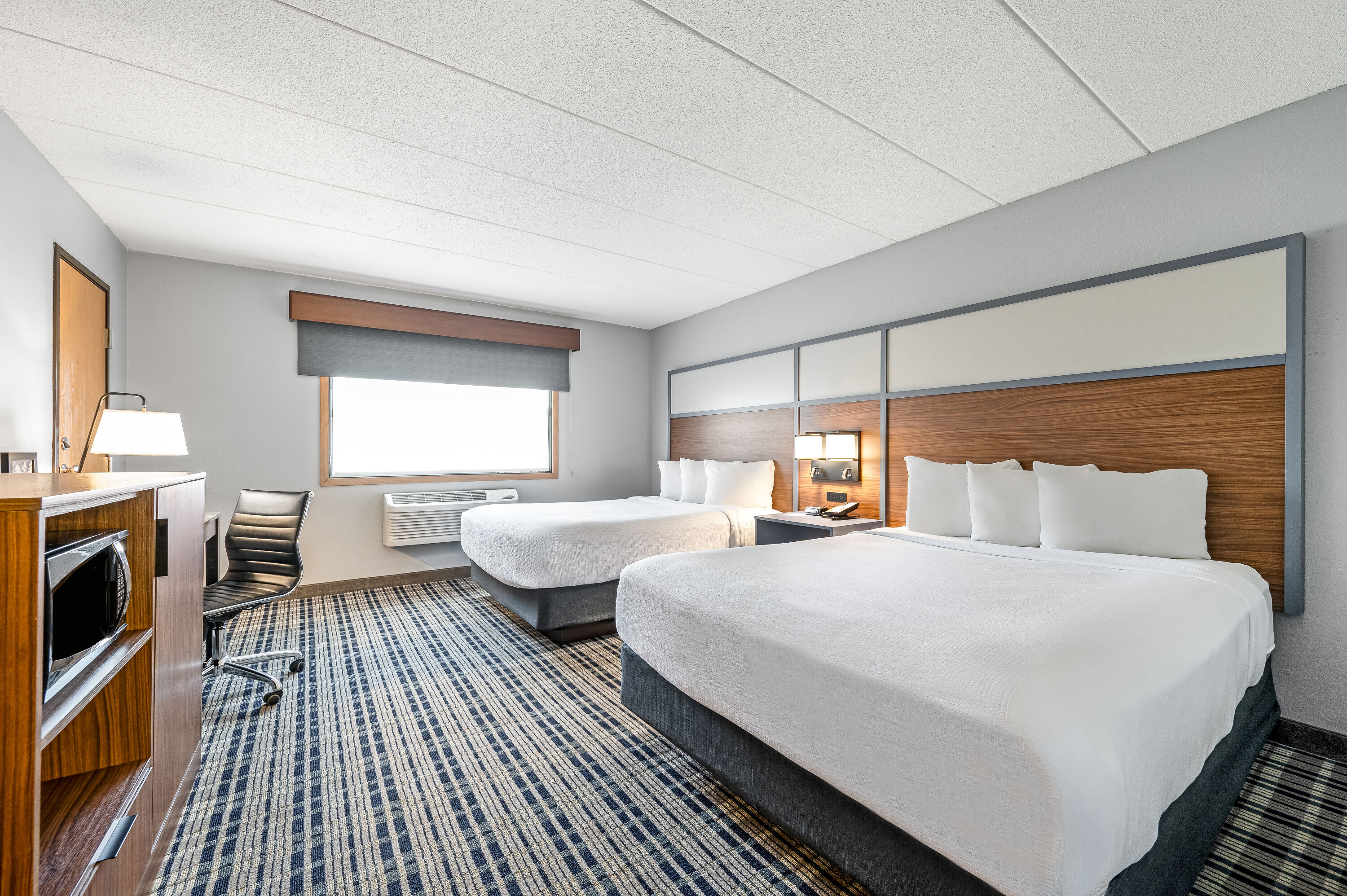 Queen bed guest room at the AmericInn by Wyndham Bemidji in Bemidji, Minnesota