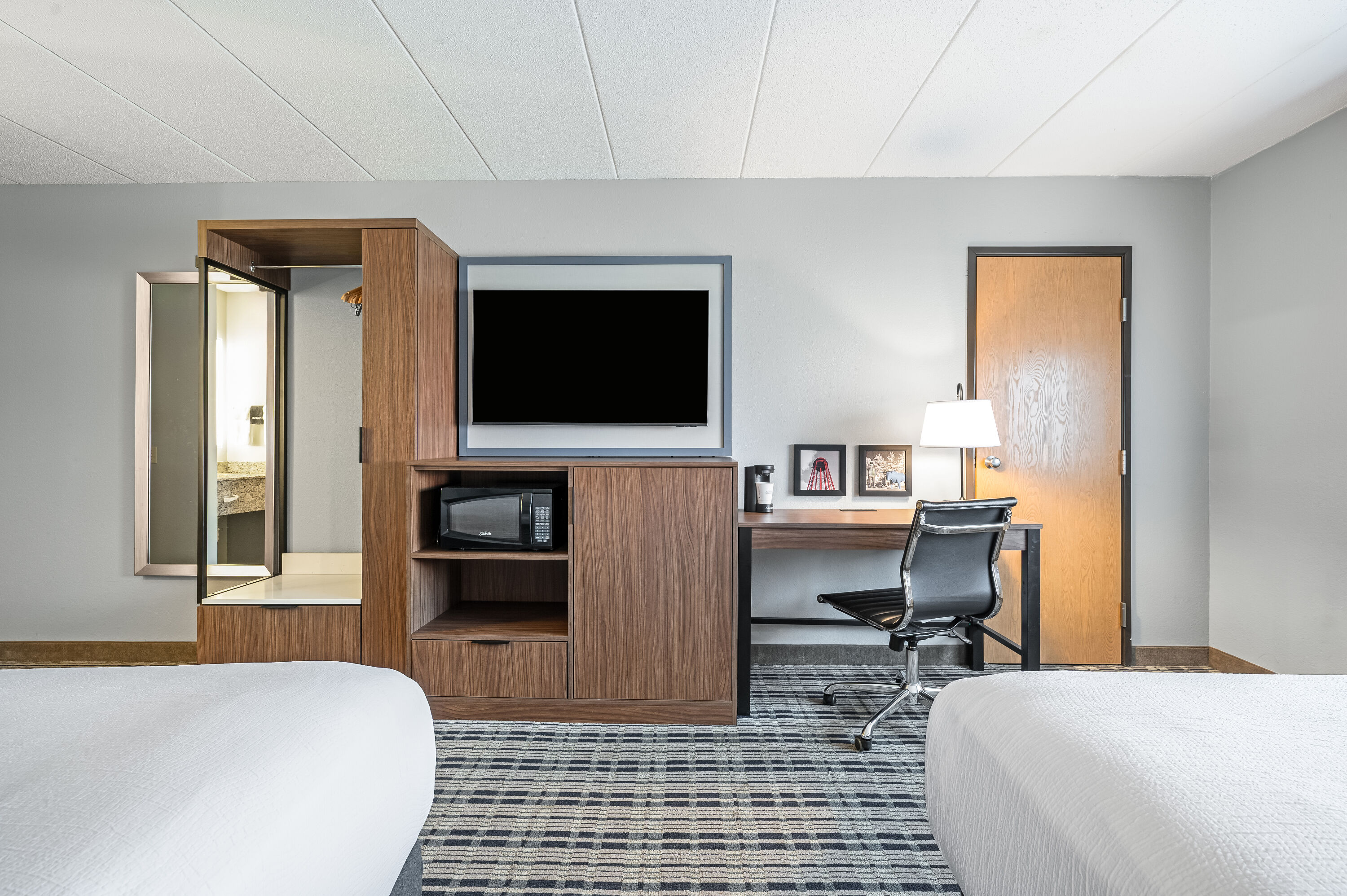 Queen bed guest room at the AmericInn by Wyndham Bemidji in Bemidji, Minnesota