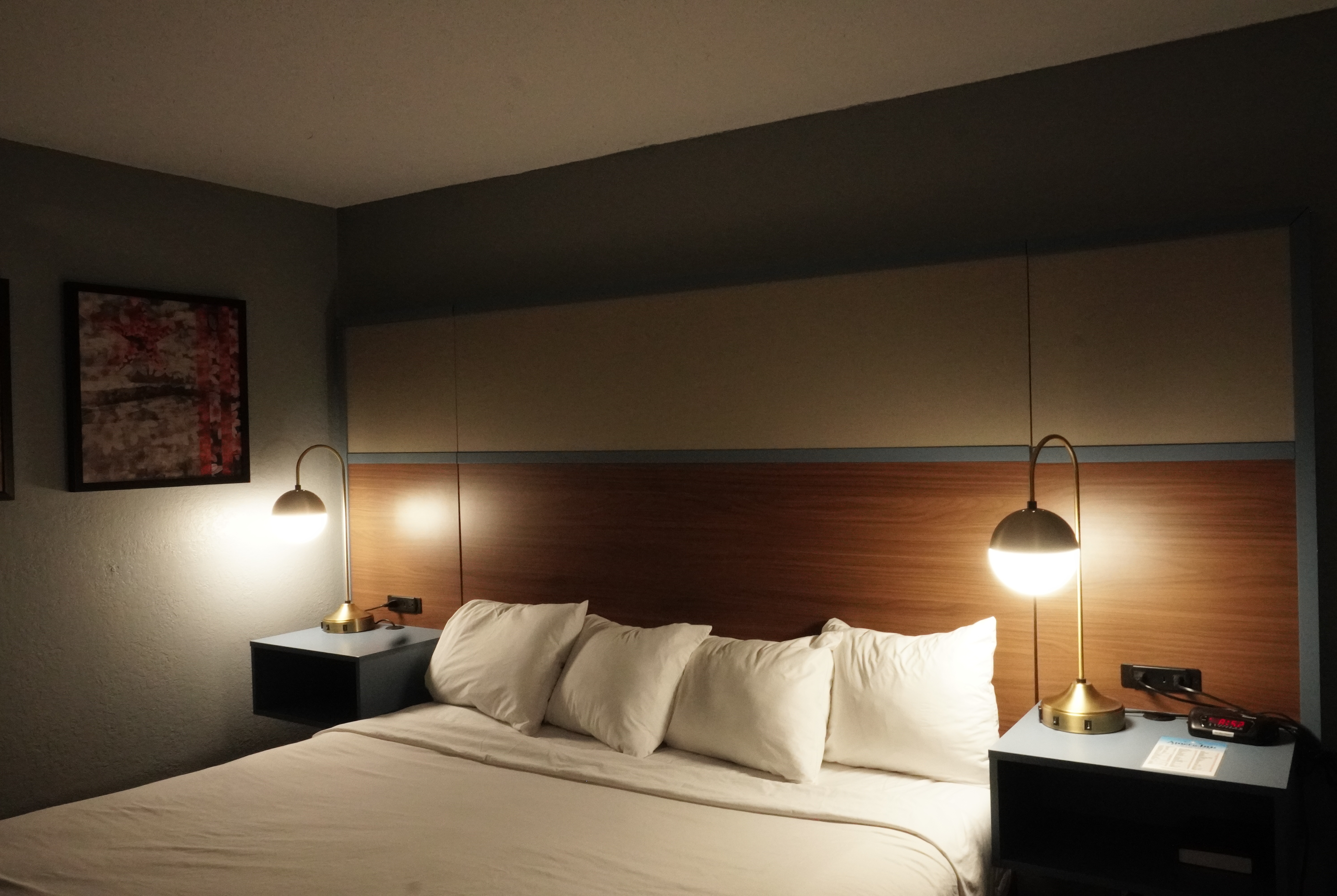 Queen bed guest room at the AmericInn by Wyndham Forest Lake in Forest Lake, Minnesota