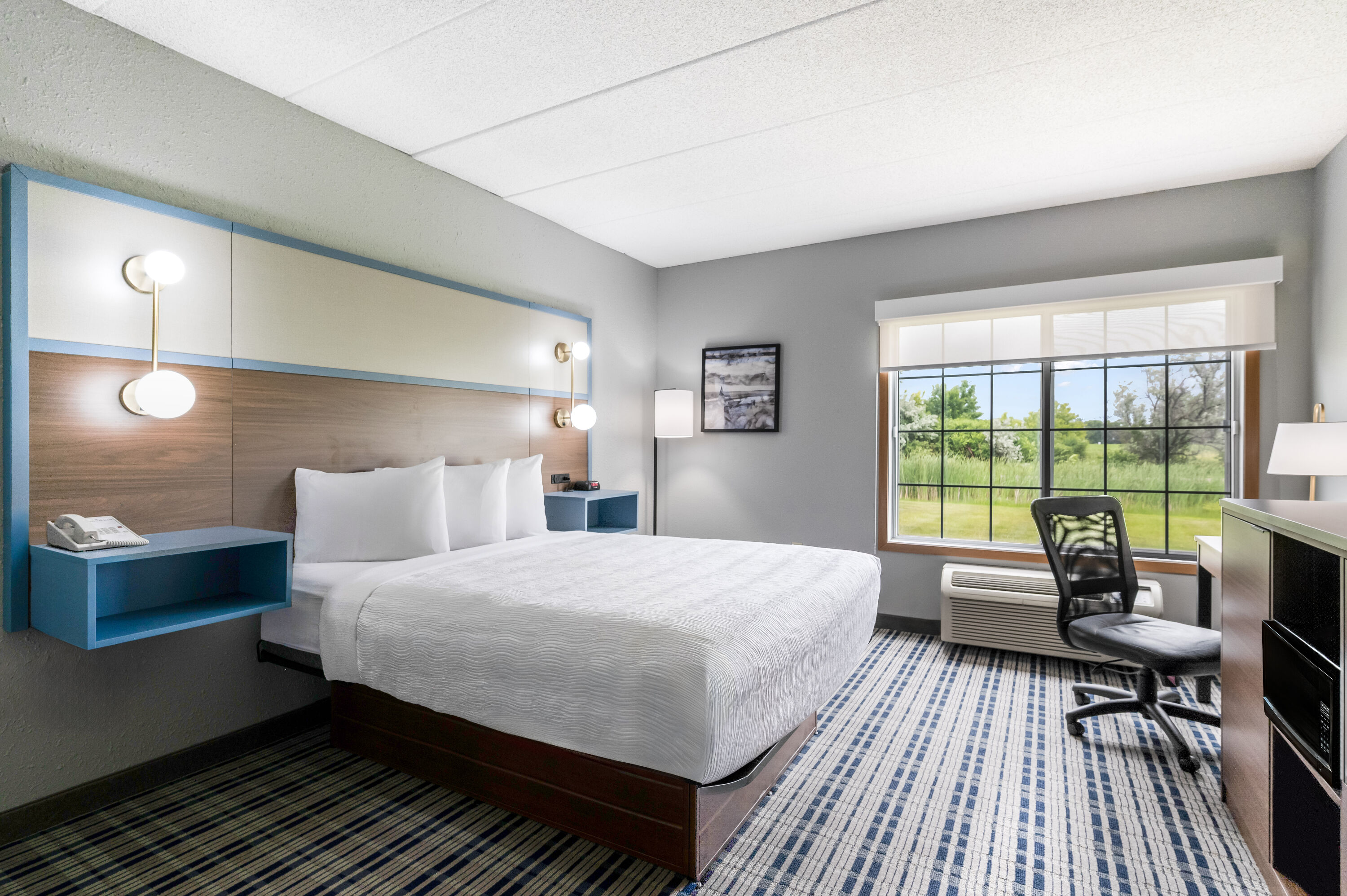 Queen bed guest room at the AmericInn by Wyndham Hutchinson in Hutchinson, Minnesota