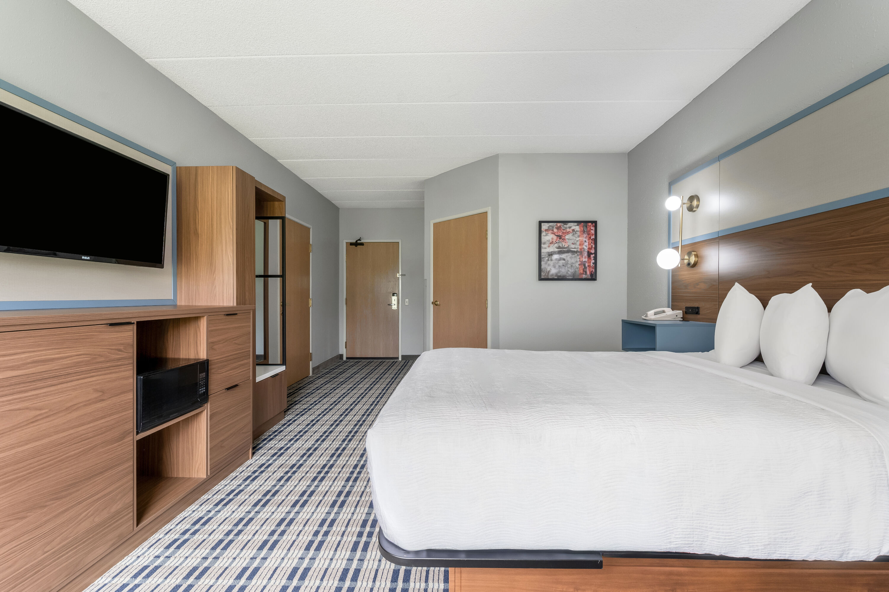 Queen bed guest room at the AmericInn by Wyndham Hutchinson in Hutchinson, Minnesota