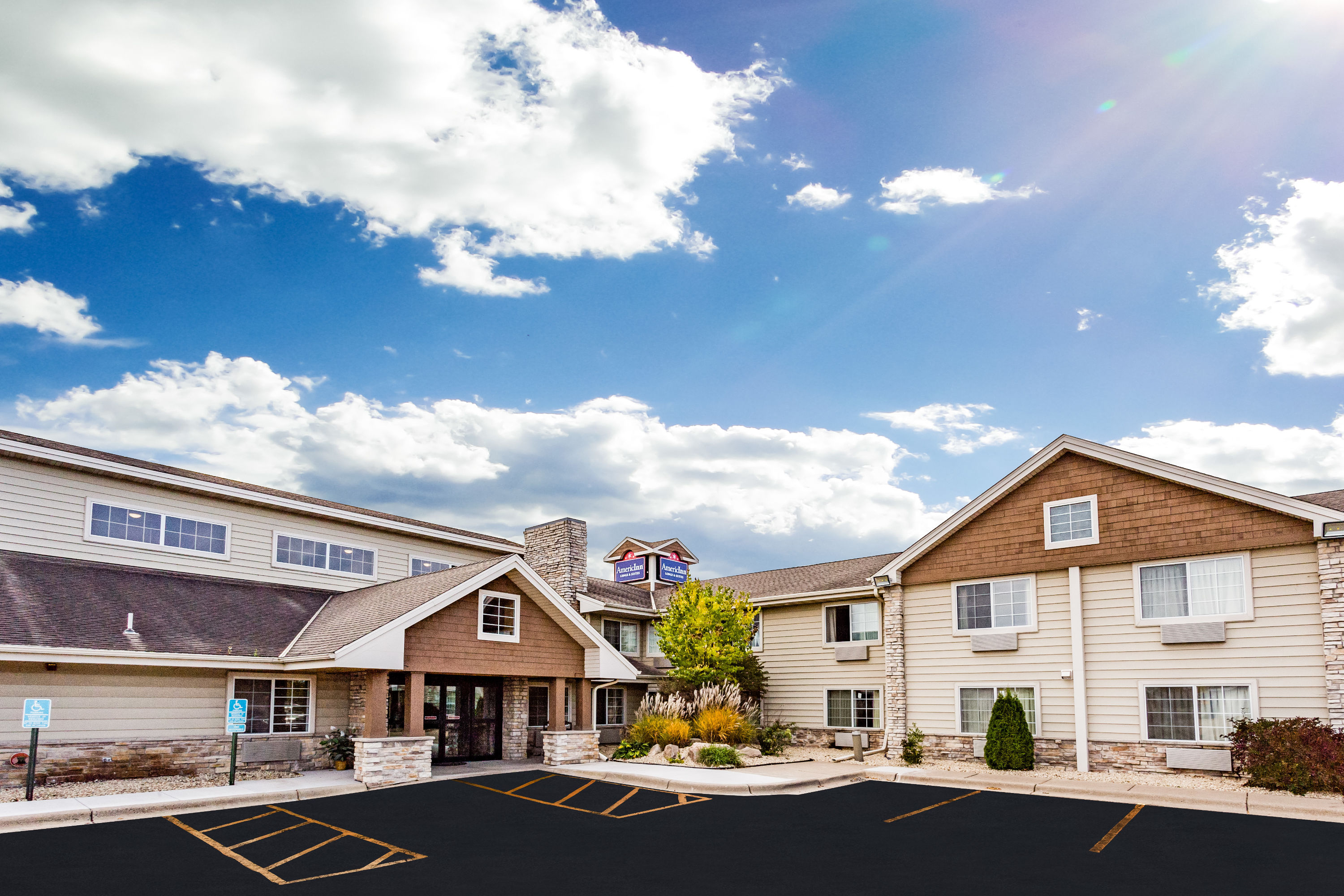 Exterior Day Image of AmericInn by Wyndham Hotel and Suites Long Lake hotel in Long Lake, Minnesota
