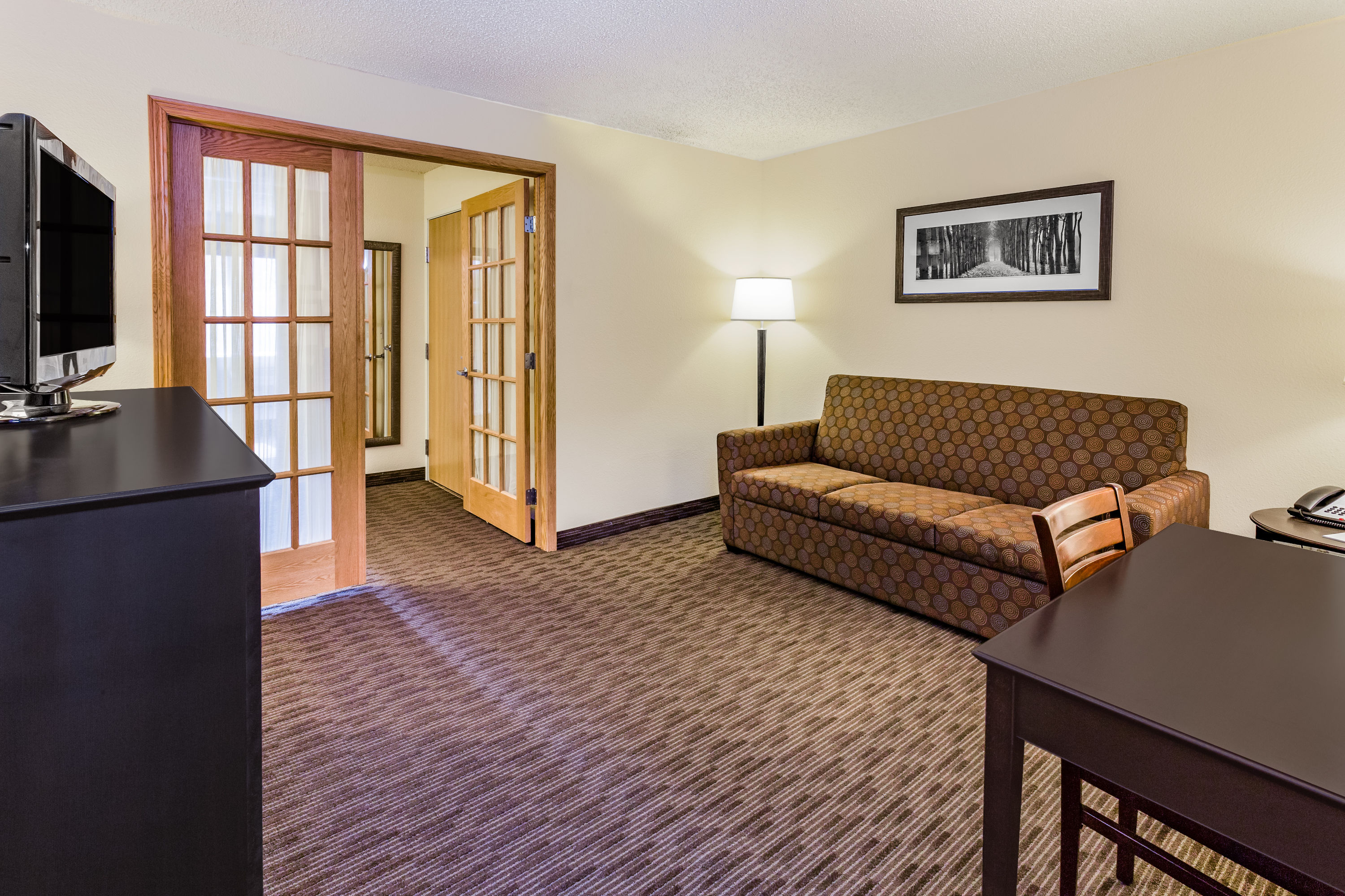 AmericInn by Wyndham Hotel and Suites Long Lake suite living room in Long Lake, Minnesota