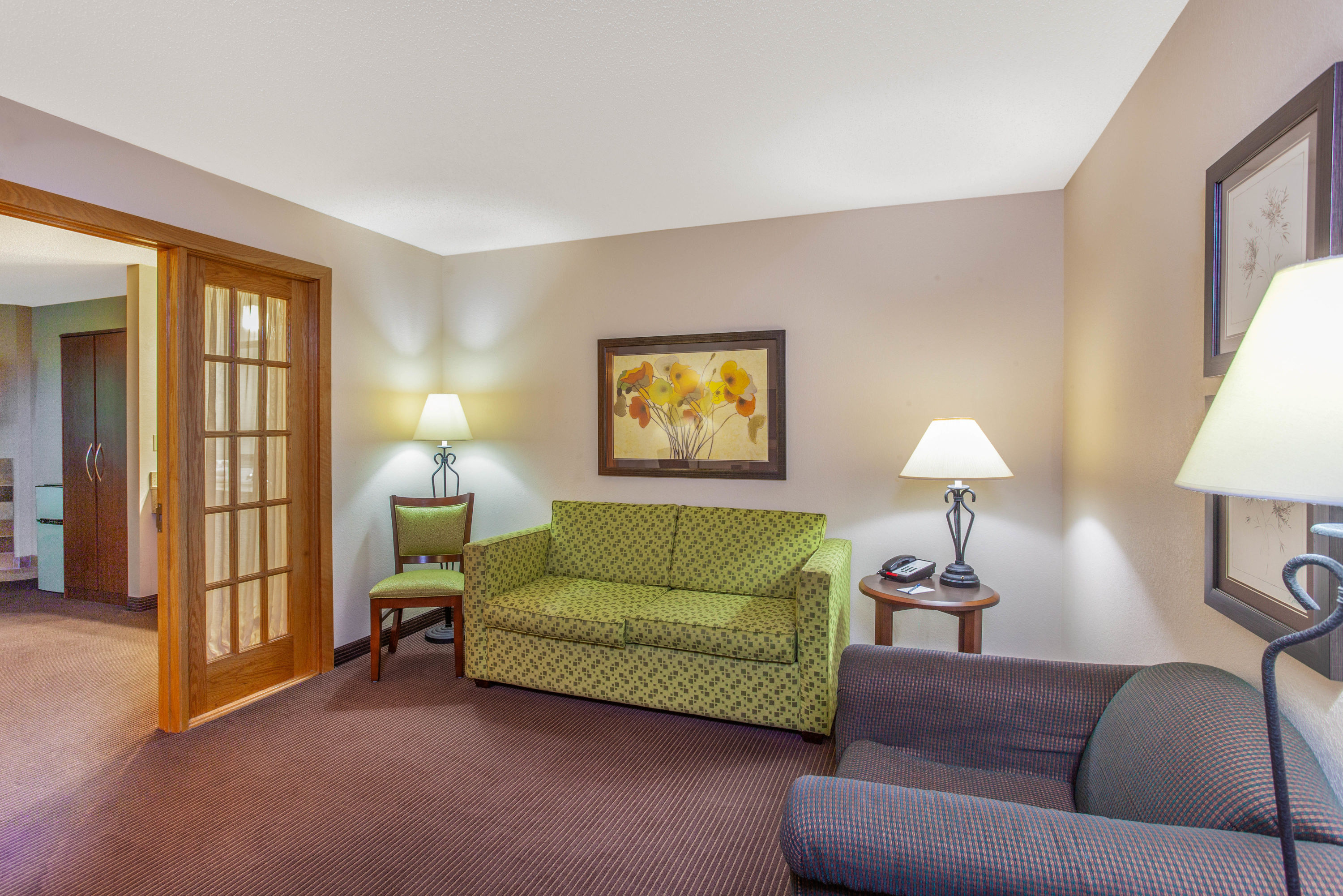 AmericInn by Wyndham Stillwater suite living room in Oak Park Heights, Minnesota