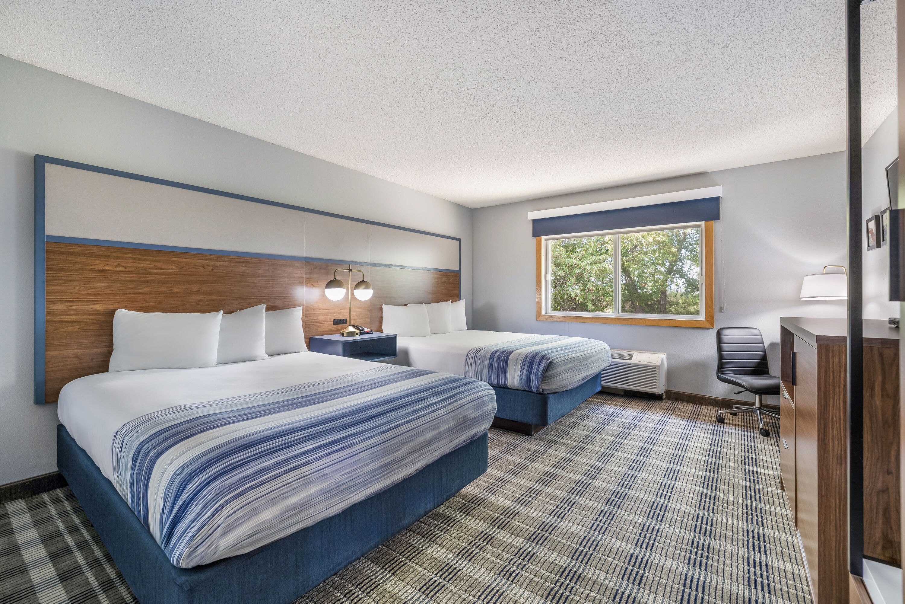 Queen bed guest room at the AmericInn by Wyndham Stillwater in Oak Park Heights, Minnesota