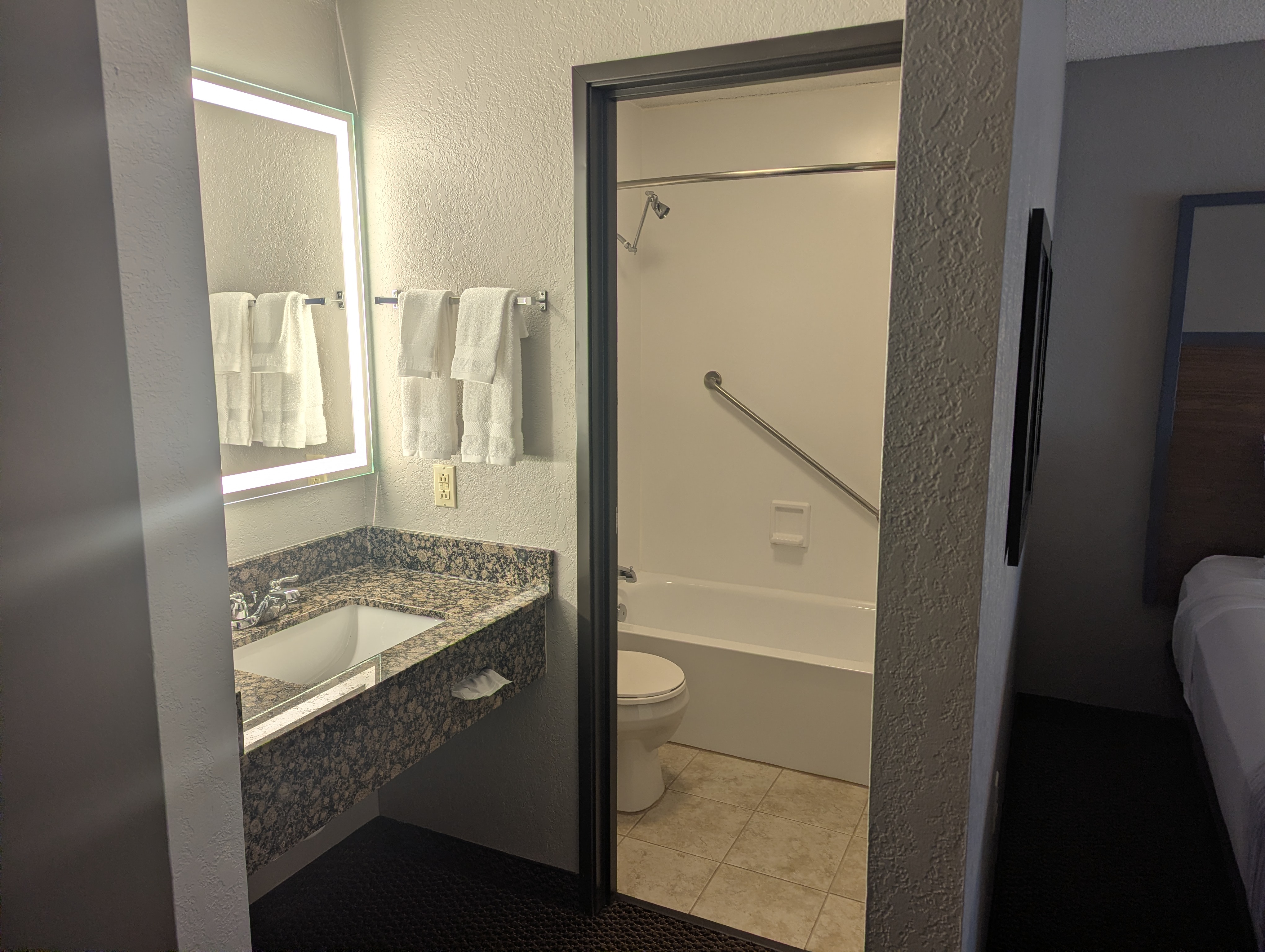 Guest room bath at the AmericInn by Wyndham St. Peter in Saint Peter, Minnesota