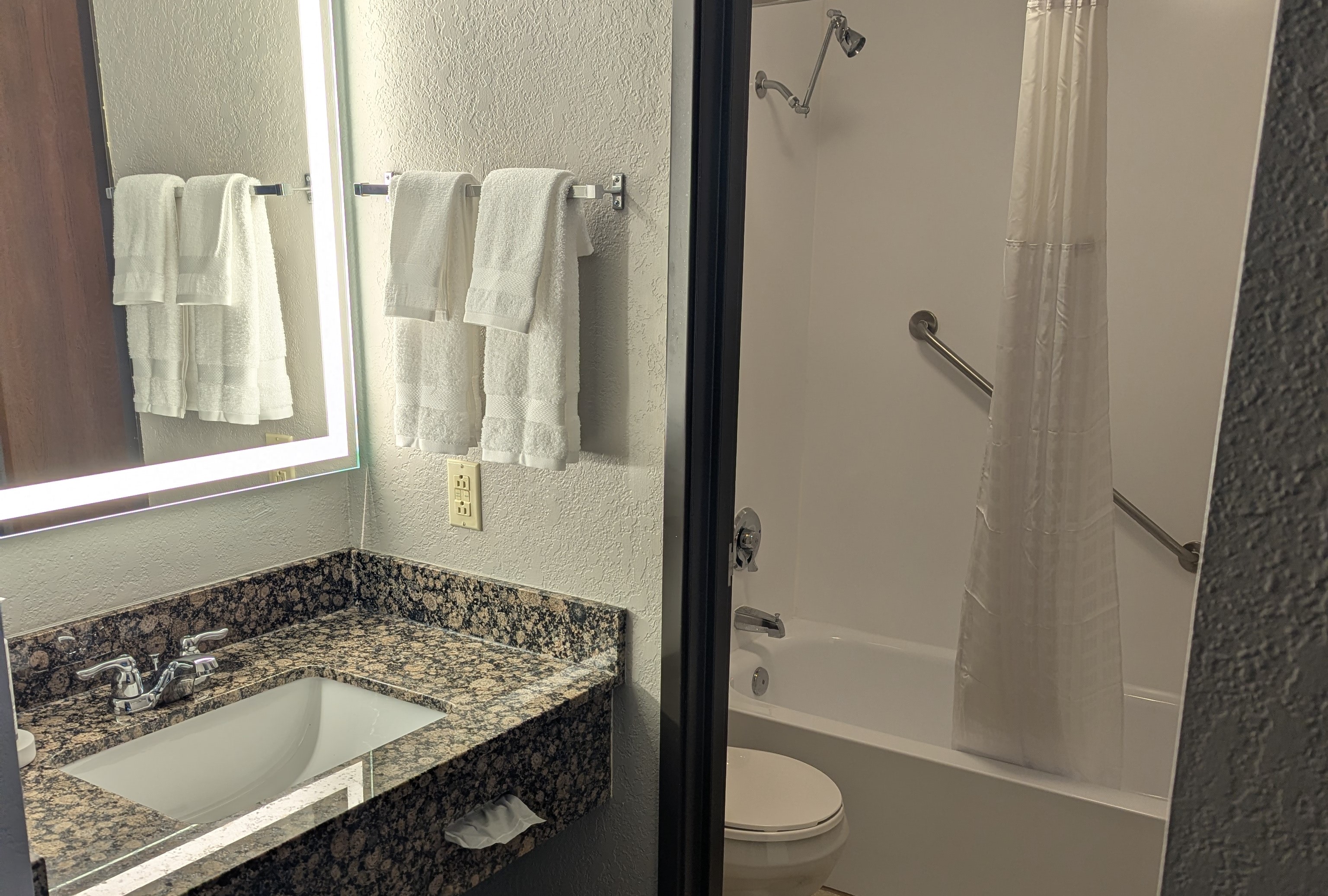 Guest room bath at the AmericInn by Wyndham St. Peter in Saint Peter, Minnesota