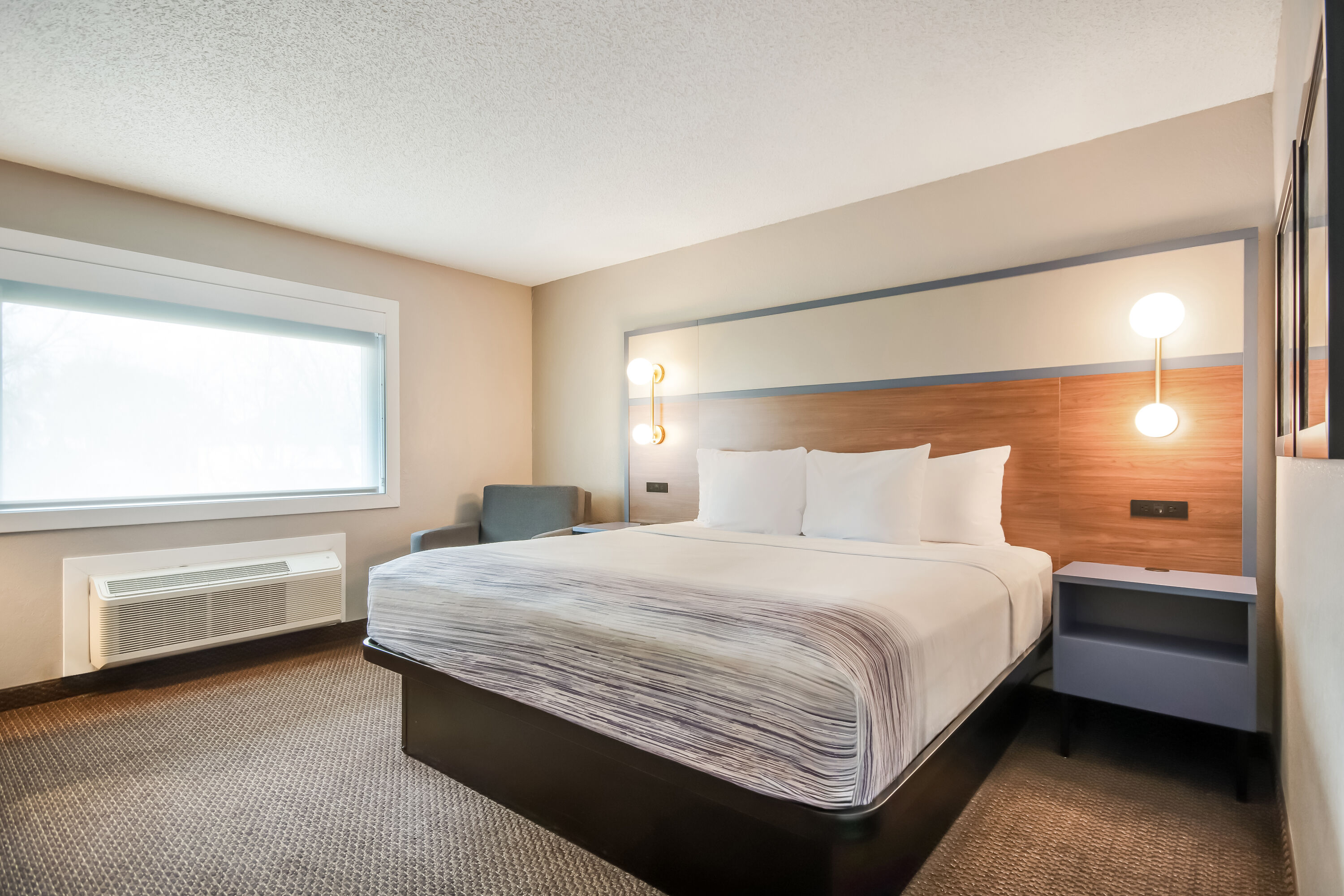 King bed guest room at the AmericInn by Wyndham St. Peter in Saint Peter, Minnesota