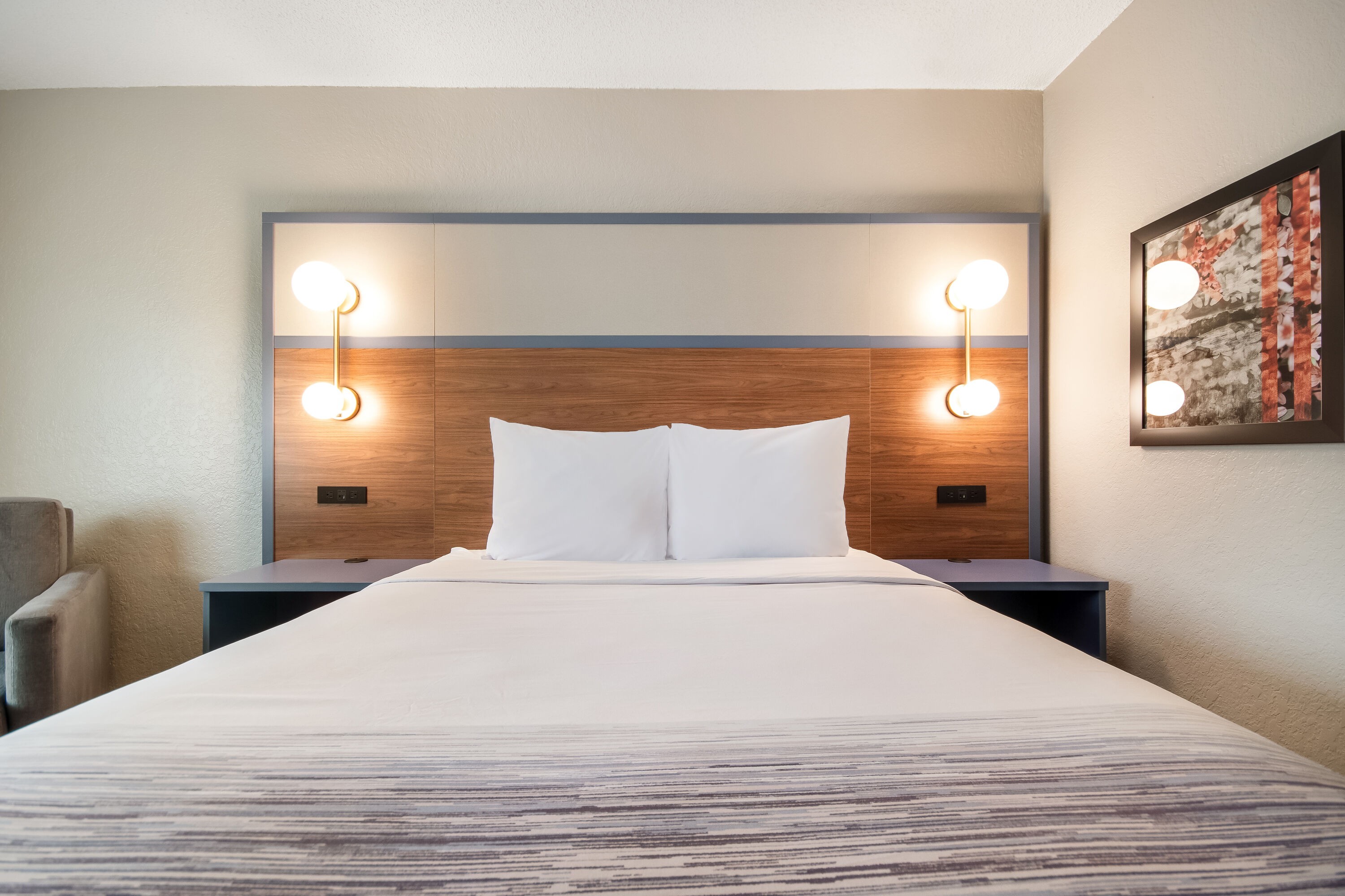 Queen bed guest room at the AmericInn by Wyndham St. Peter in Saint Peter, Minnesota