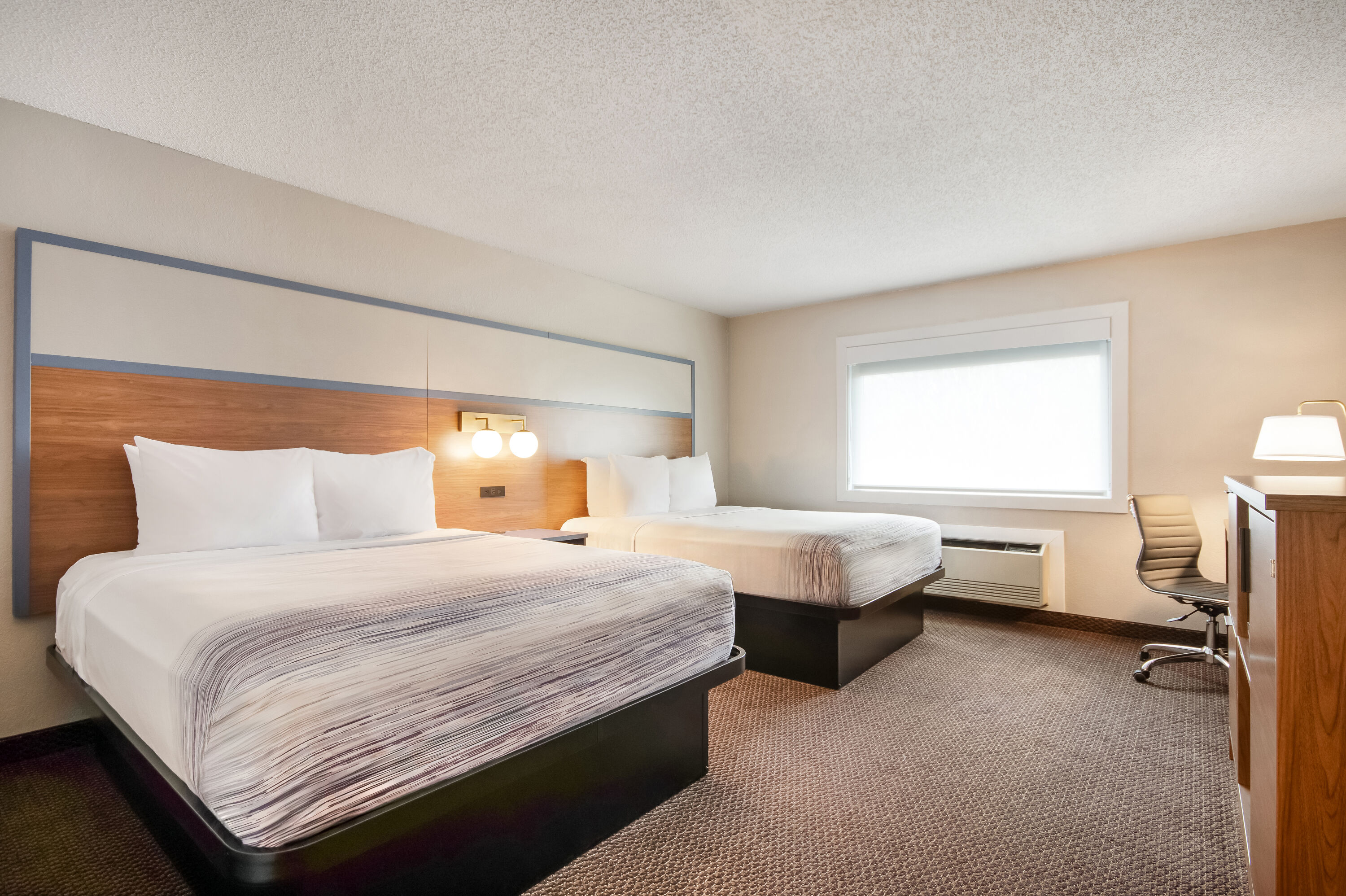 Queen bed guest room at the AmericInn by Wyndham St. Peter in Saint Peter, Minnesota