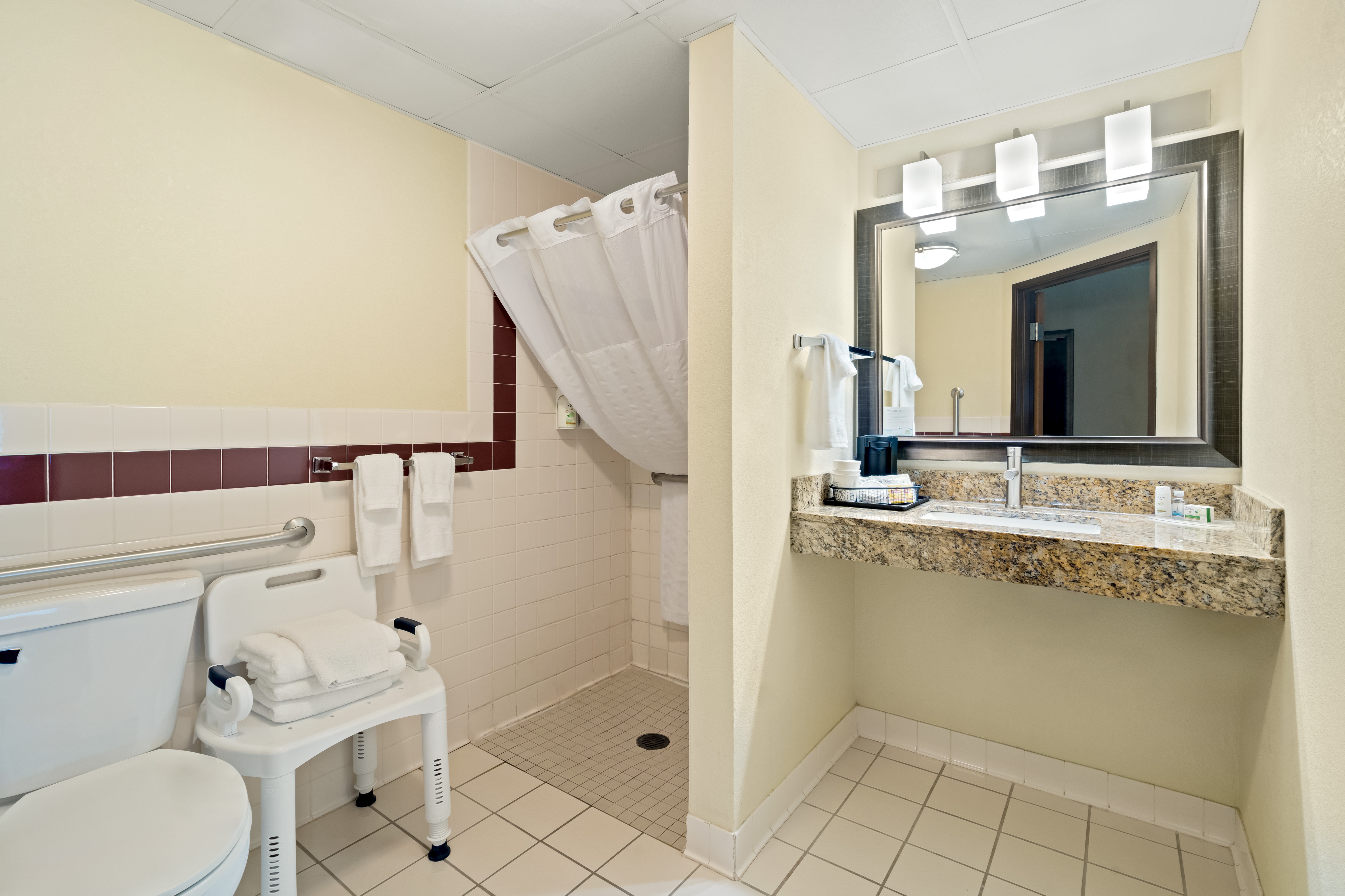 Guest room bath at the AmericInn by Wyndham Bismarck in Bismarck, North Dakota