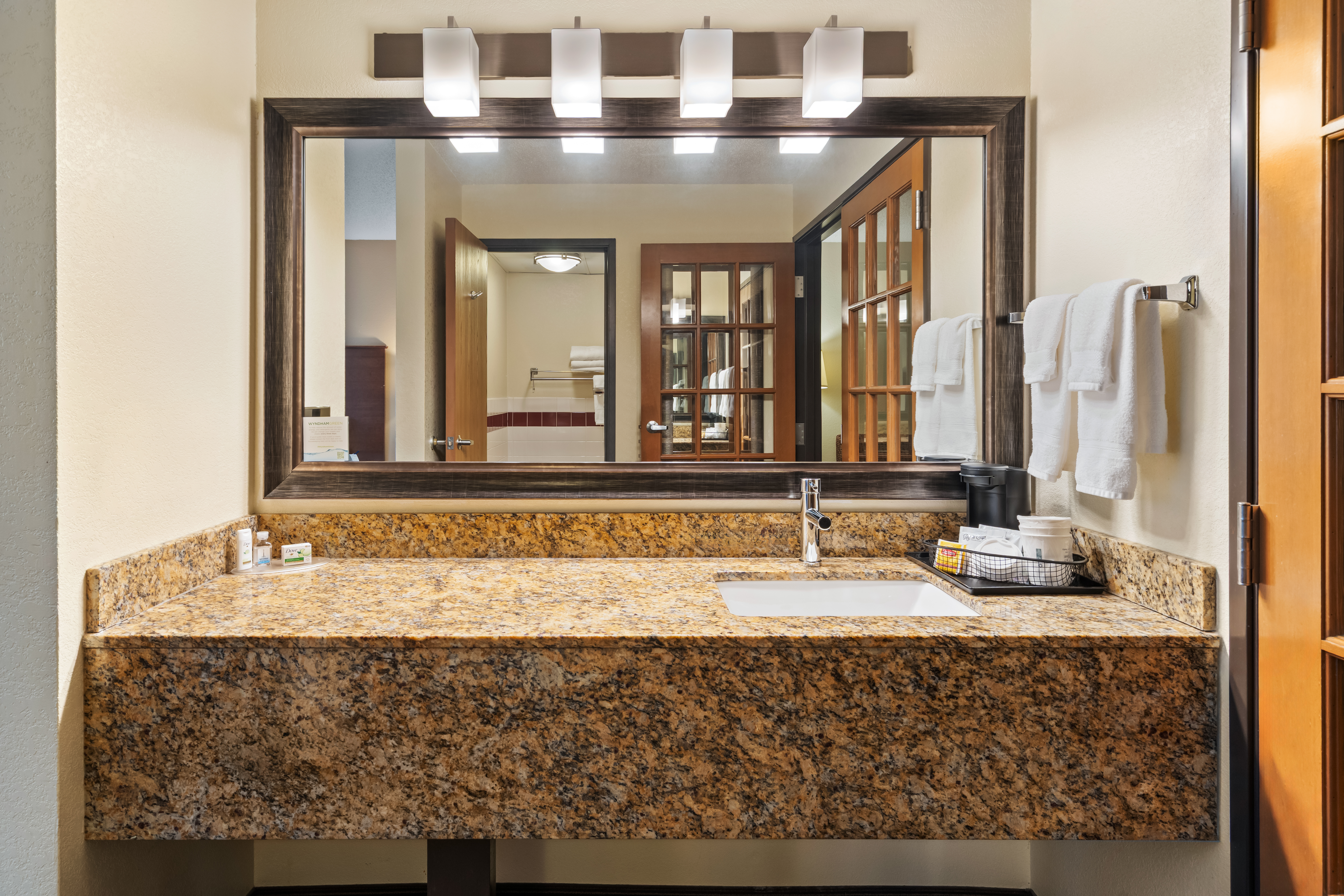 Guest room bath at the AmericInn by Wyndham Bismarck in Bismarck, North Dakota