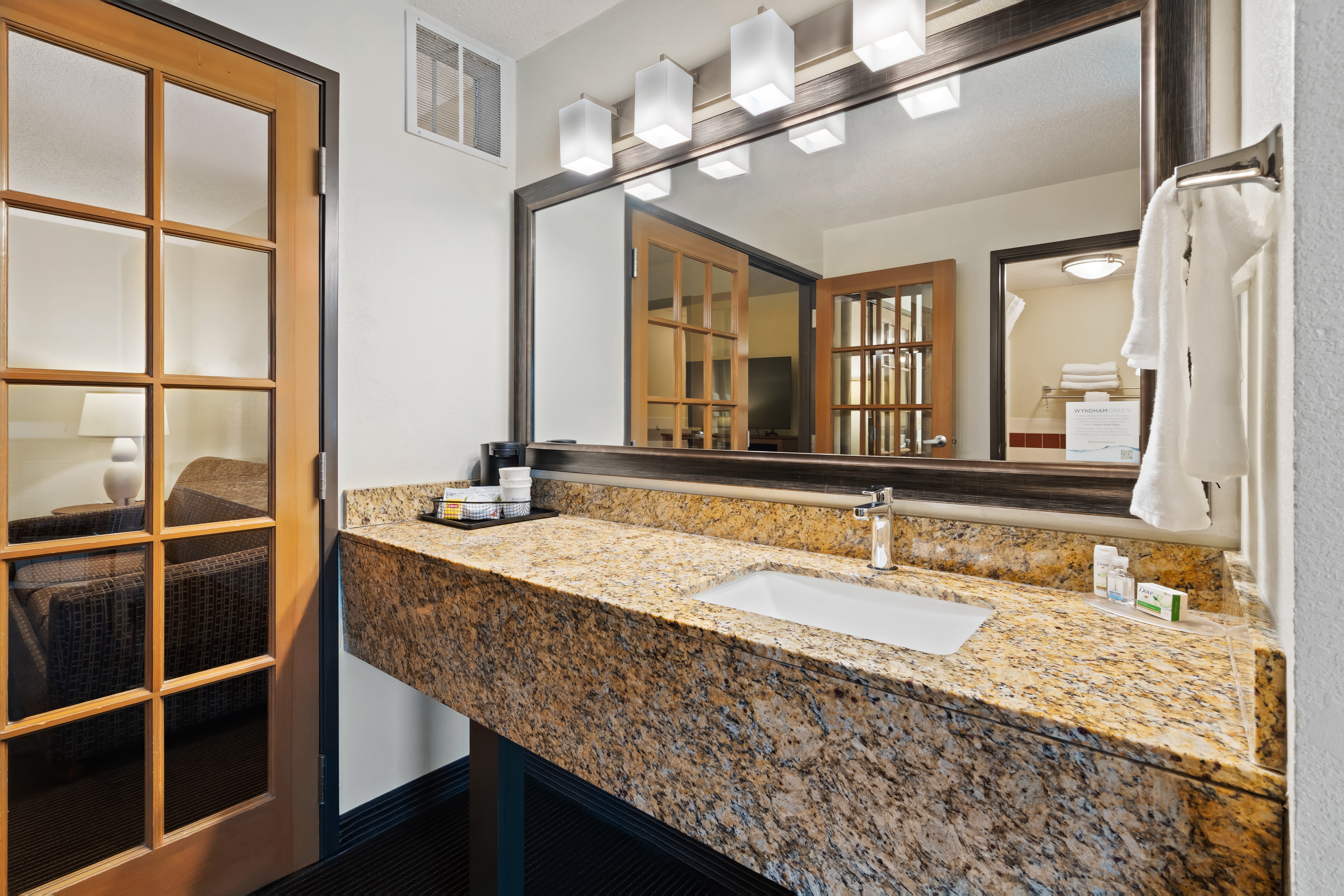 Guest room bath at the AmericInn by Wyndham Bismarck in Bismarck, North Dakota
