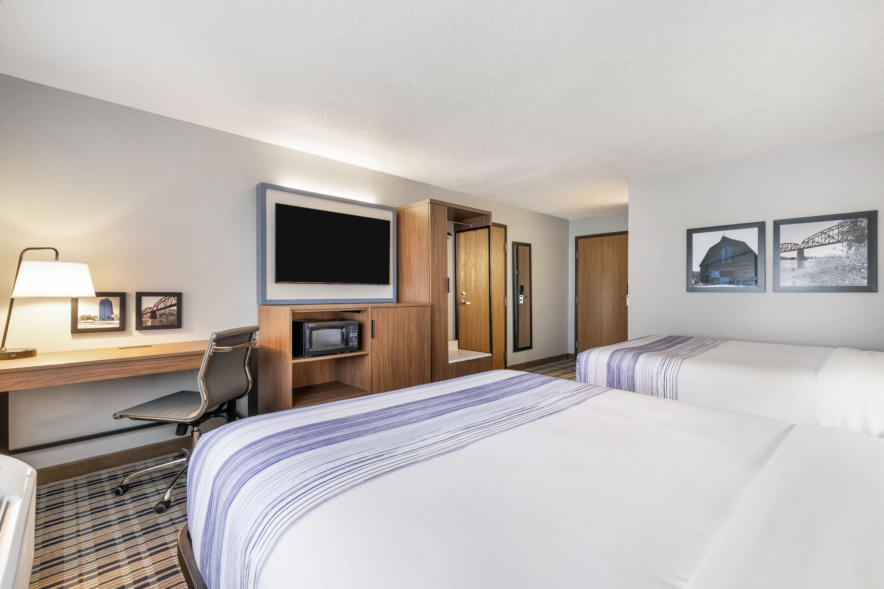 Queen bed guest room at the AmericInn by Wyndham Bismarck in Bismarck, North Dakota
