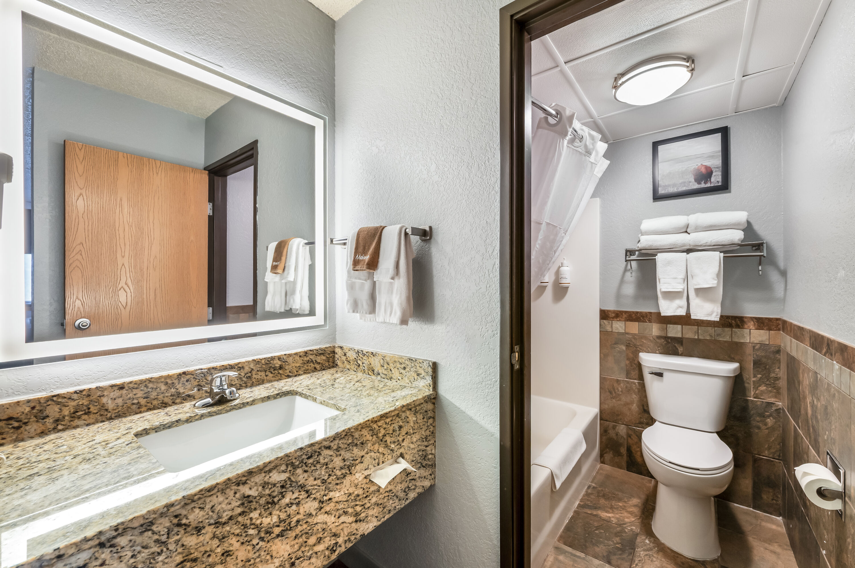 Guest room bath at the AmericInn by Wyndham Dickinson in Dickinson, North Dakota