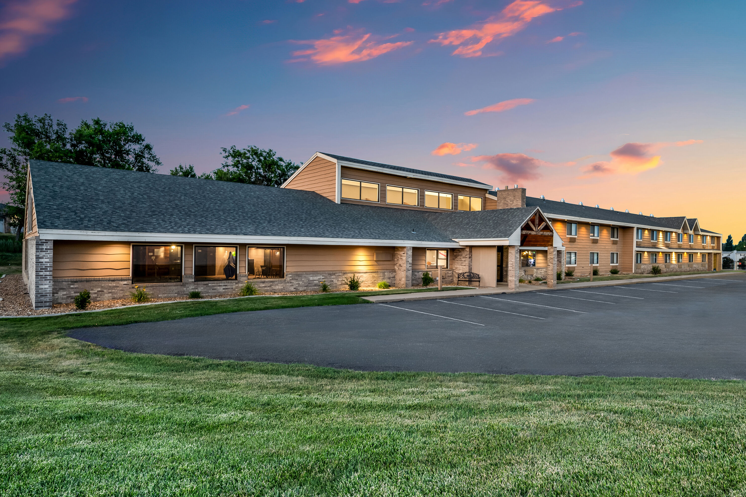 Exterior Dusk Image of AmericInn by Wyndham Dickinson hotel in Dickinson, North Dakota