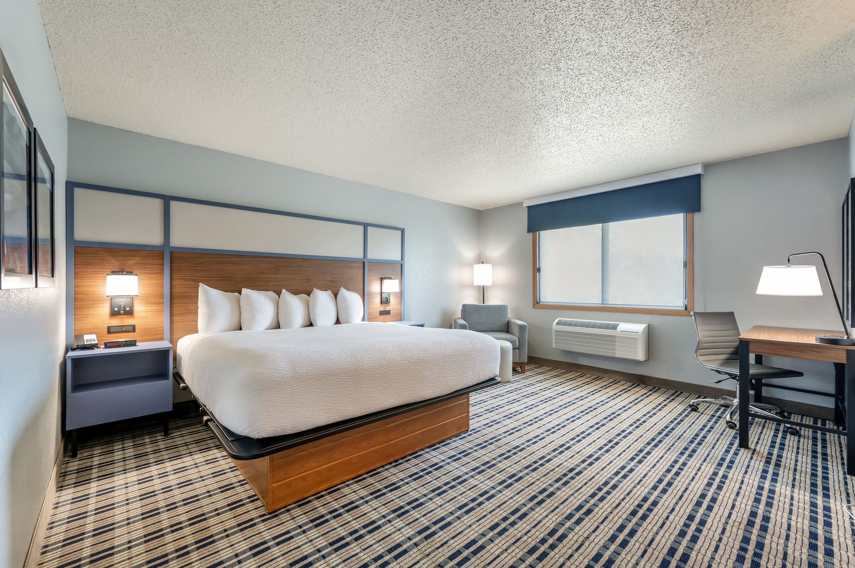 King bed guest room at the AmericInn by Wyndham Dickinson in Dickinson, North Dakota