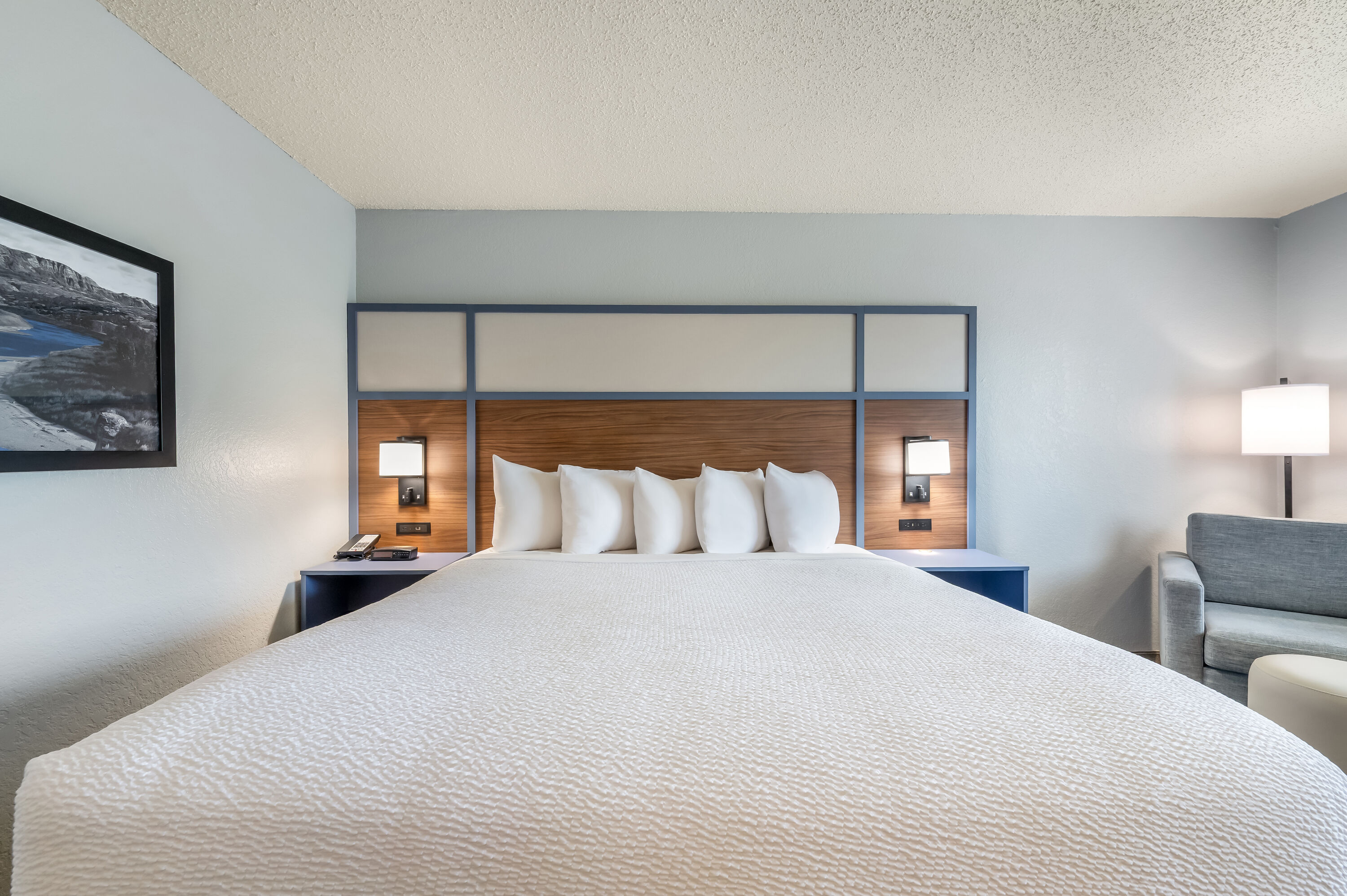 King bed guest room at the AmericInn by Wyndham Dickinson in Dickinson, North Dakota