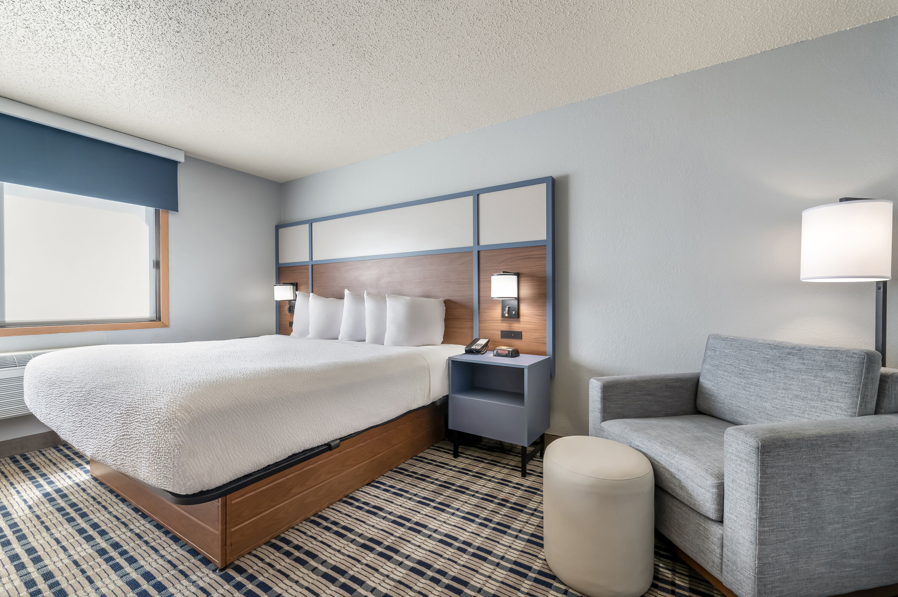 King bed guest room at the AmericInn by Wyndham Dickinson in Dickinson, North Dakota