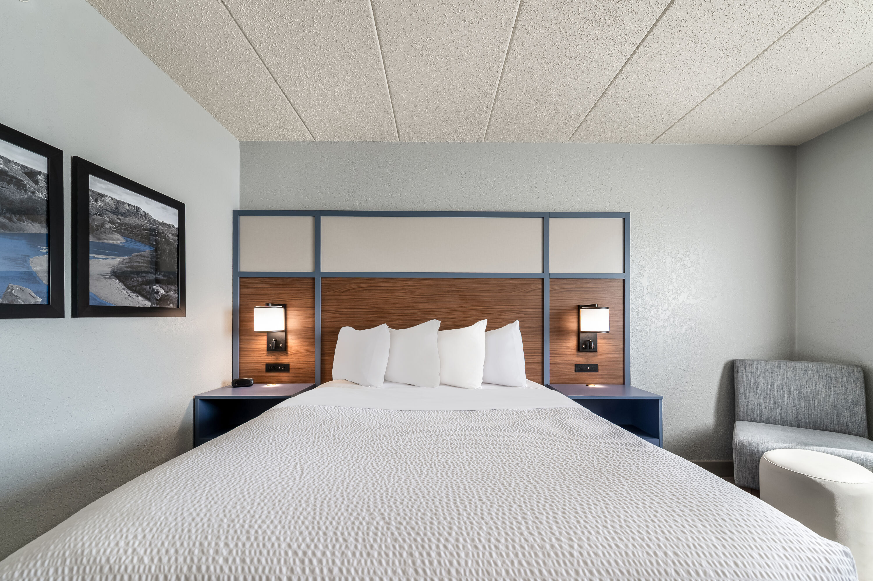 Queen bed guest room at the AmericInn by Wyndham Dickinson in Dickinson, North Dakota