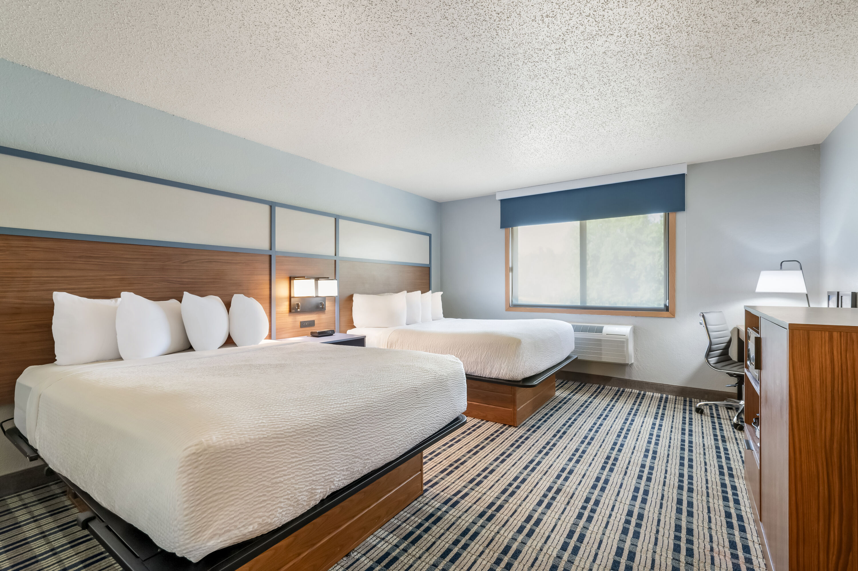 Queen bed guest room at the AmericInn by Wyndham Dickinson in Dickinson, North Dakota