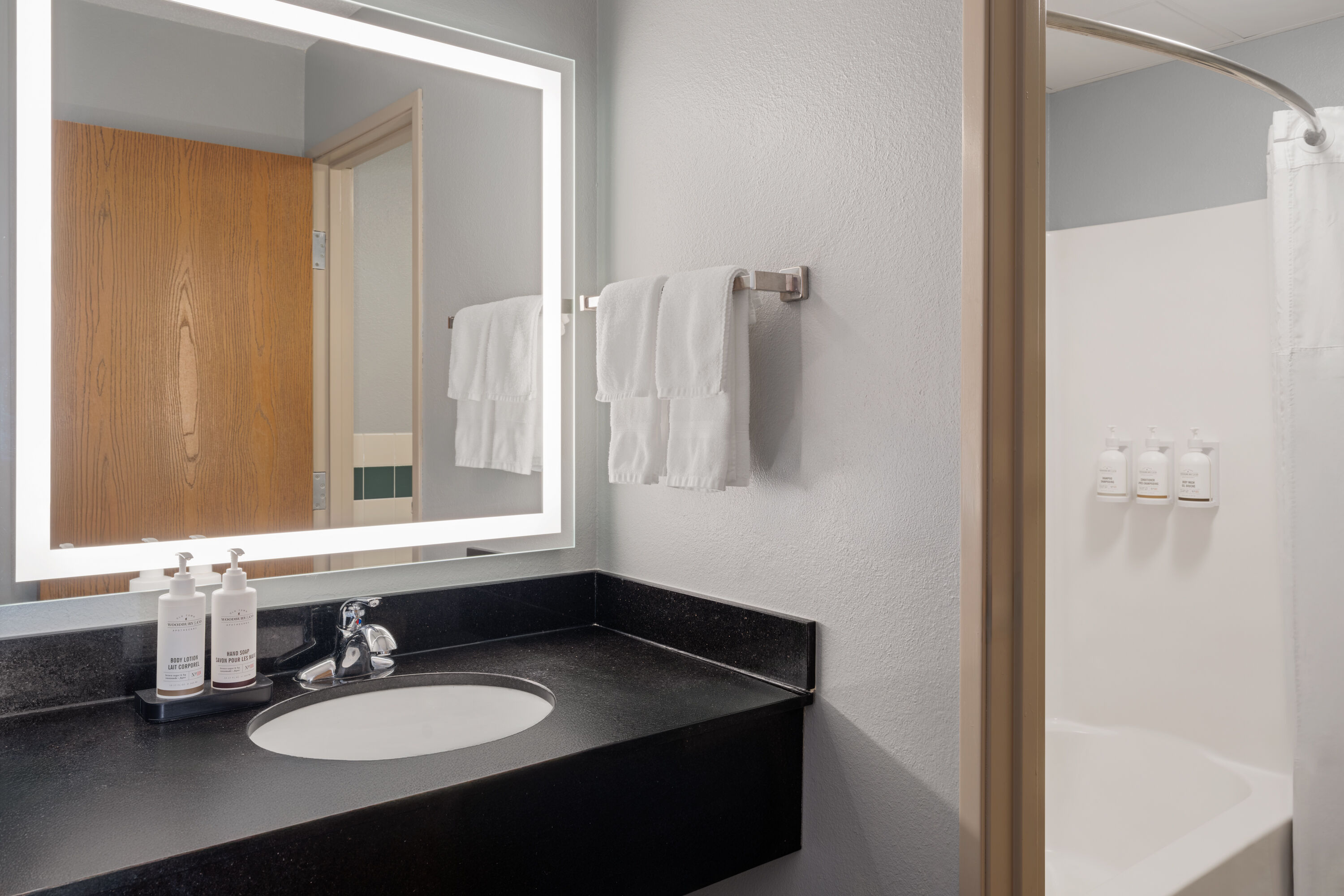 Guest room bath at the AmericInn by Wyndham Grand Forks in Grand Forks, North Dakota