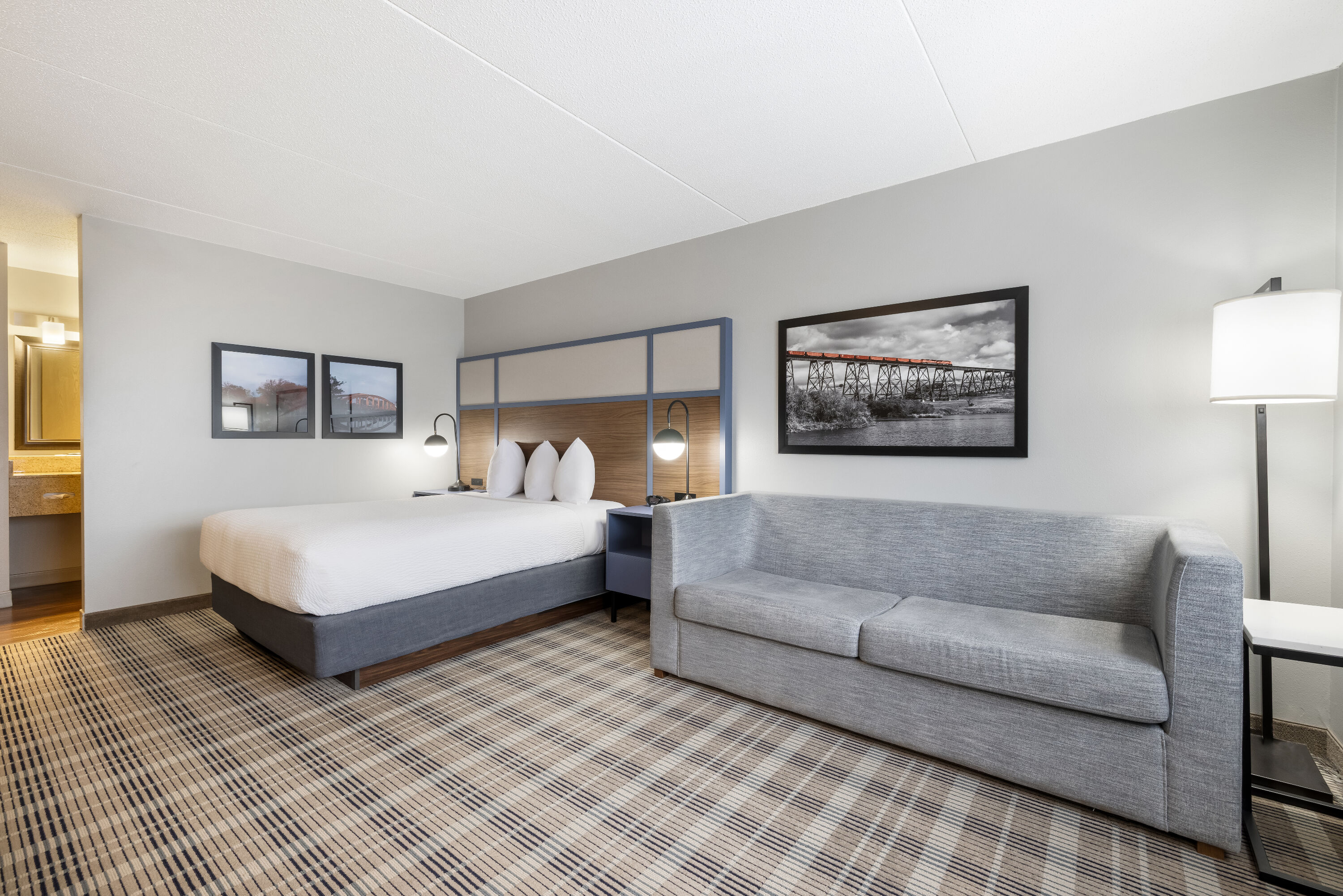 Queen bed guest room at the AmericInn by Wyndham Valley City Conference Center in Valley City, North Dakota