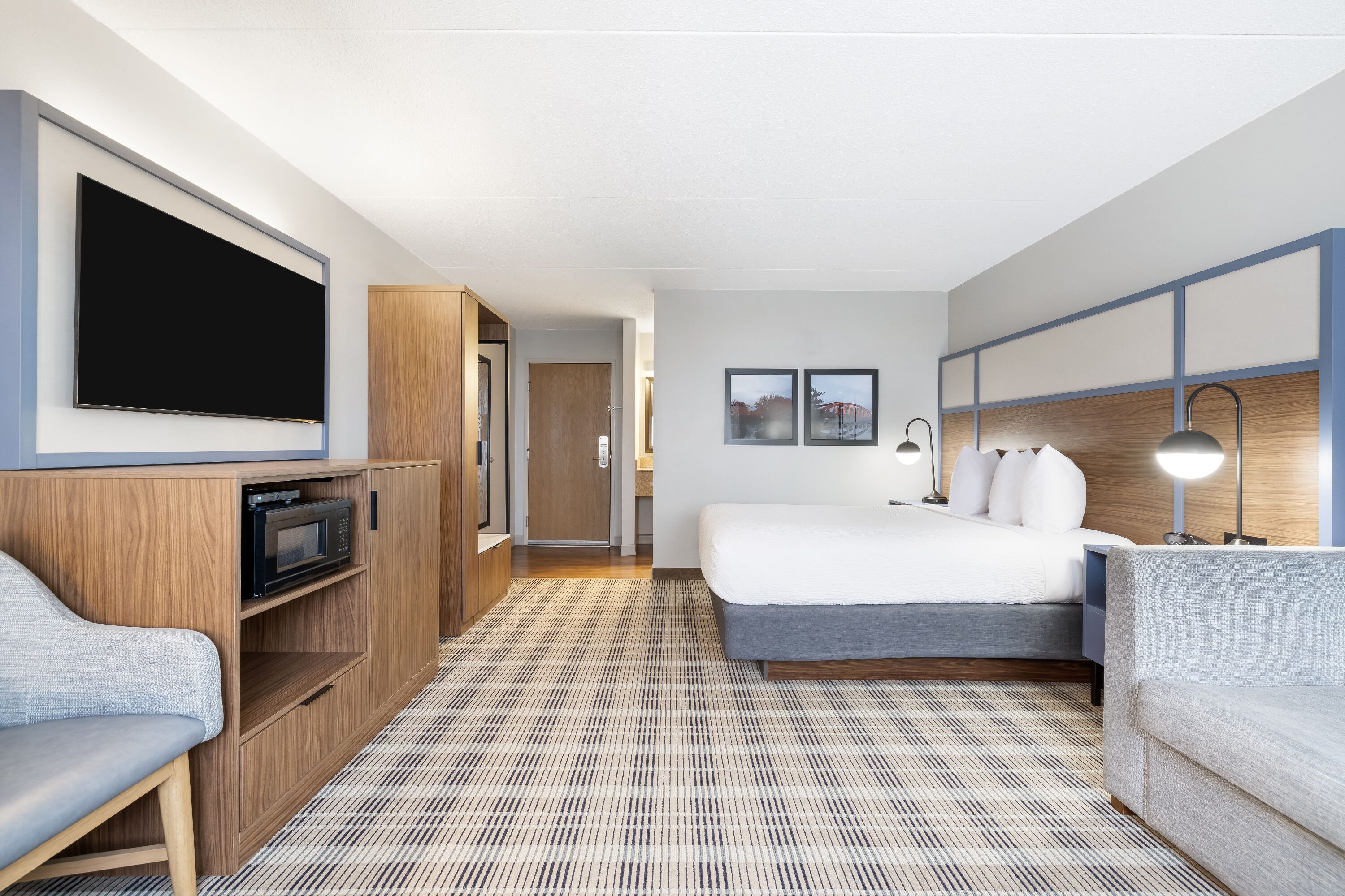 Queen bed guest room at the AmericInn by Wyndham Valley City Conference Center in Valley City, North Dakota