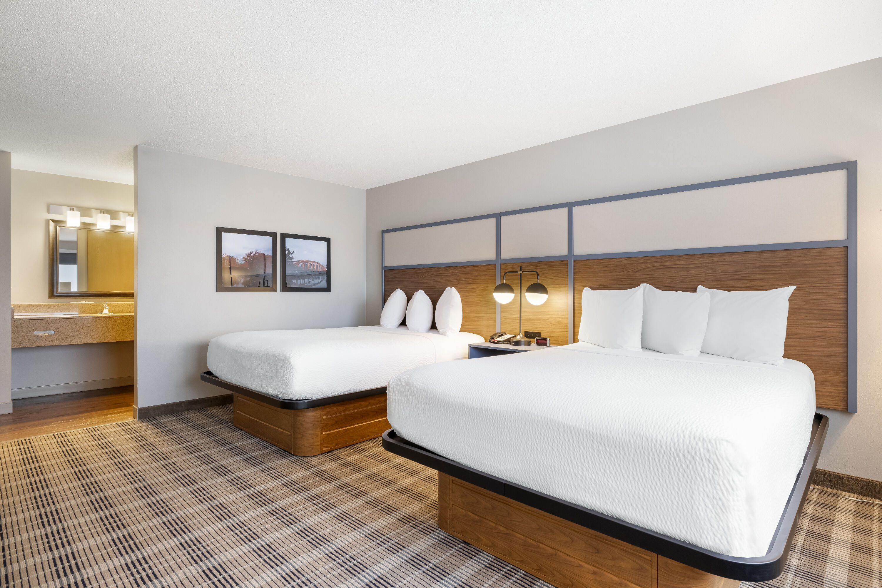 Queen bed guest room at the AmericInn by Wyndham Valley City Conference Center in Valley City, North Dakota