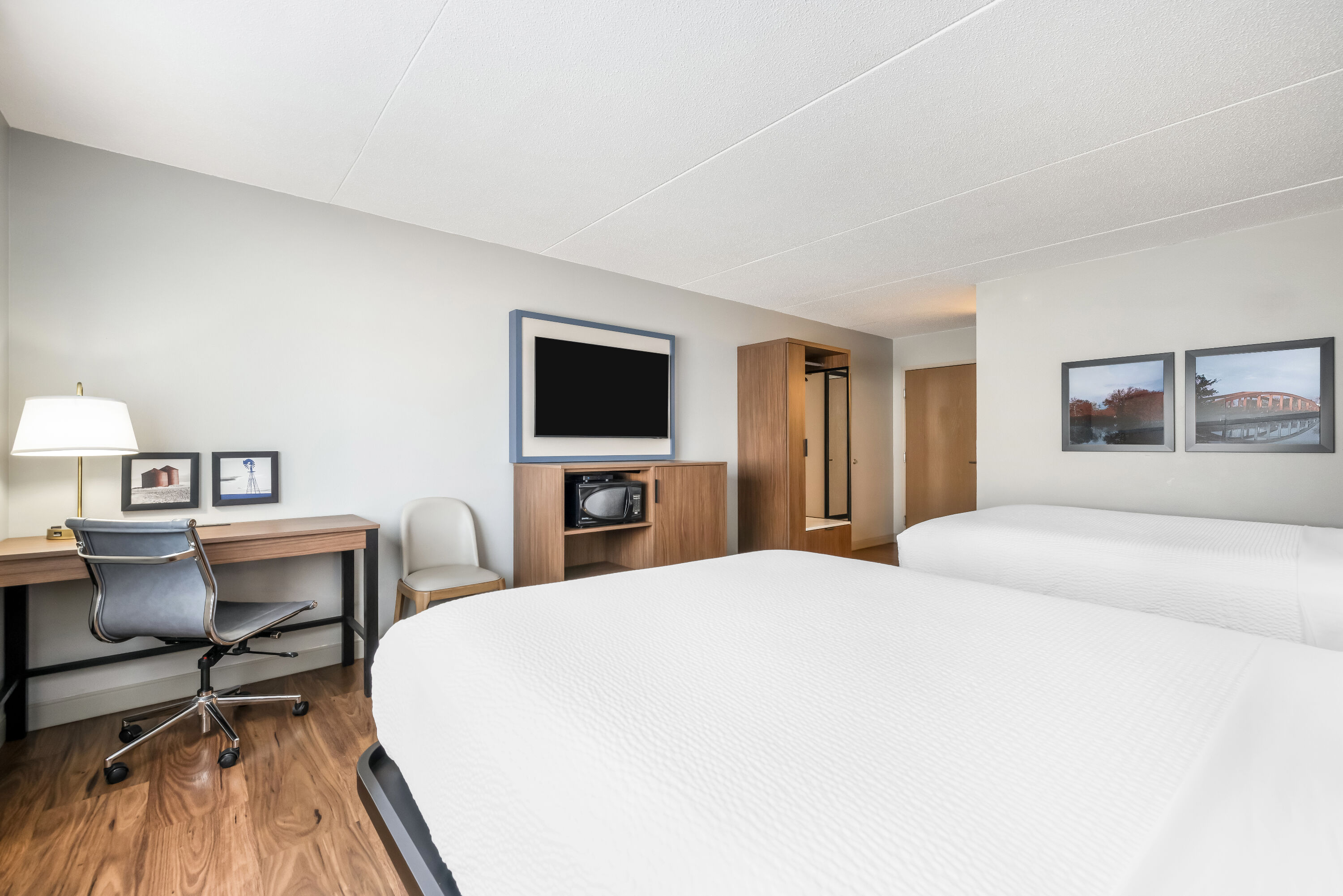 Queen bed guest room at the AmericInn by Wyndham Valley City Conference Center in Valley City, North Dakota