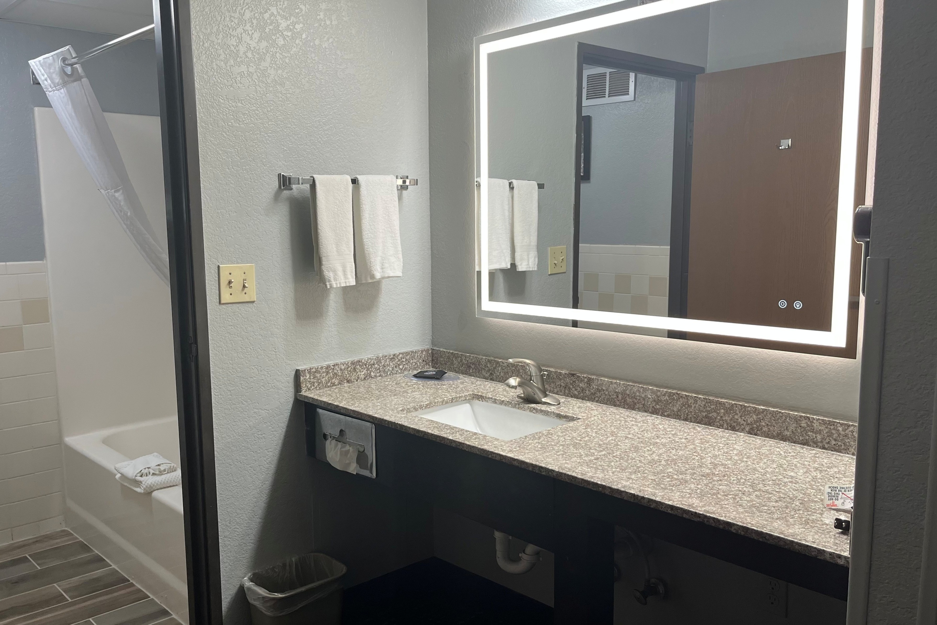 Guest room bath at the AmericInn by Wyndham Lincoln North in Lincoln, Nebraska