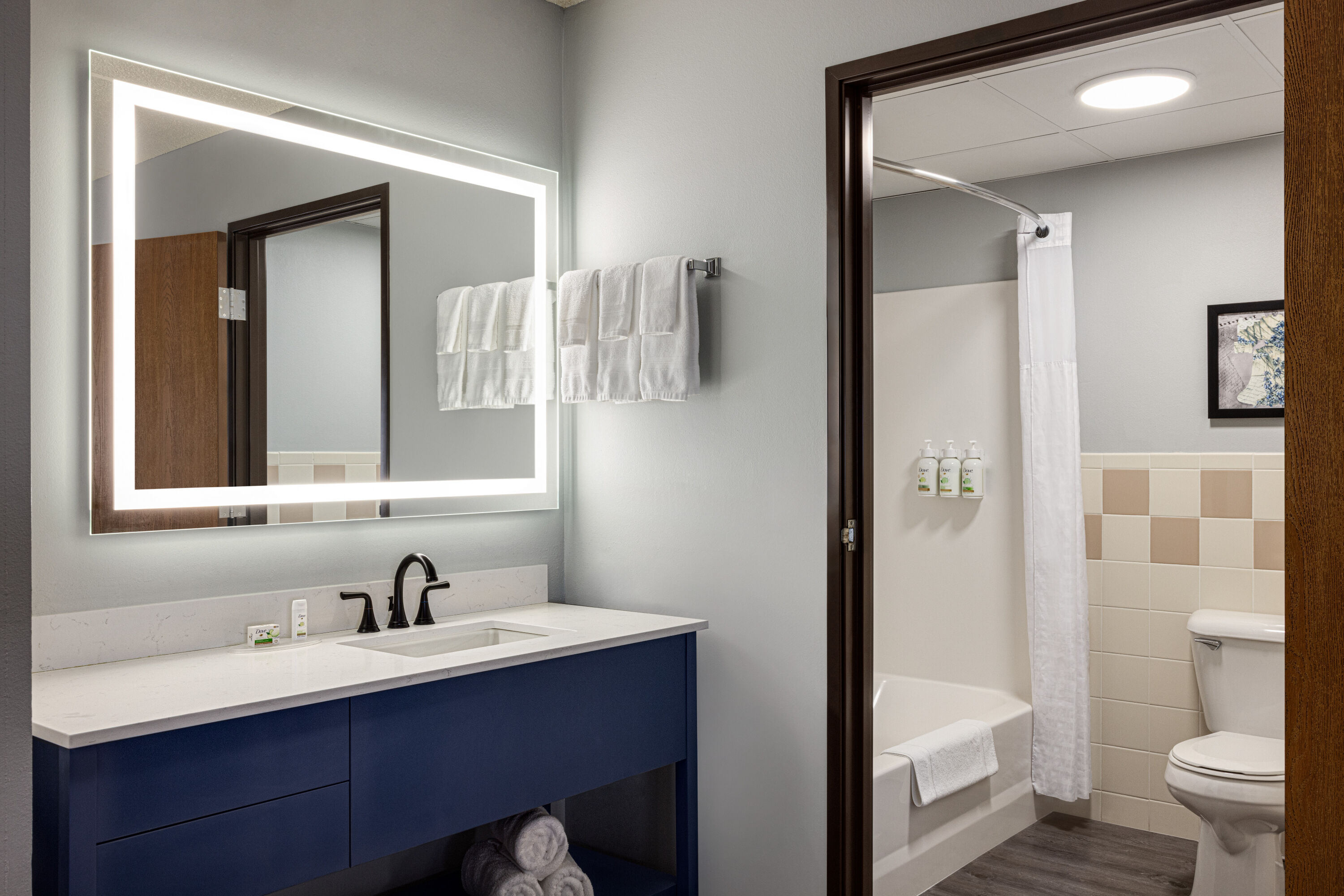 Guest room bath at the AmericInn by Wyndham Lincoln South in Lincoln, Nebraska