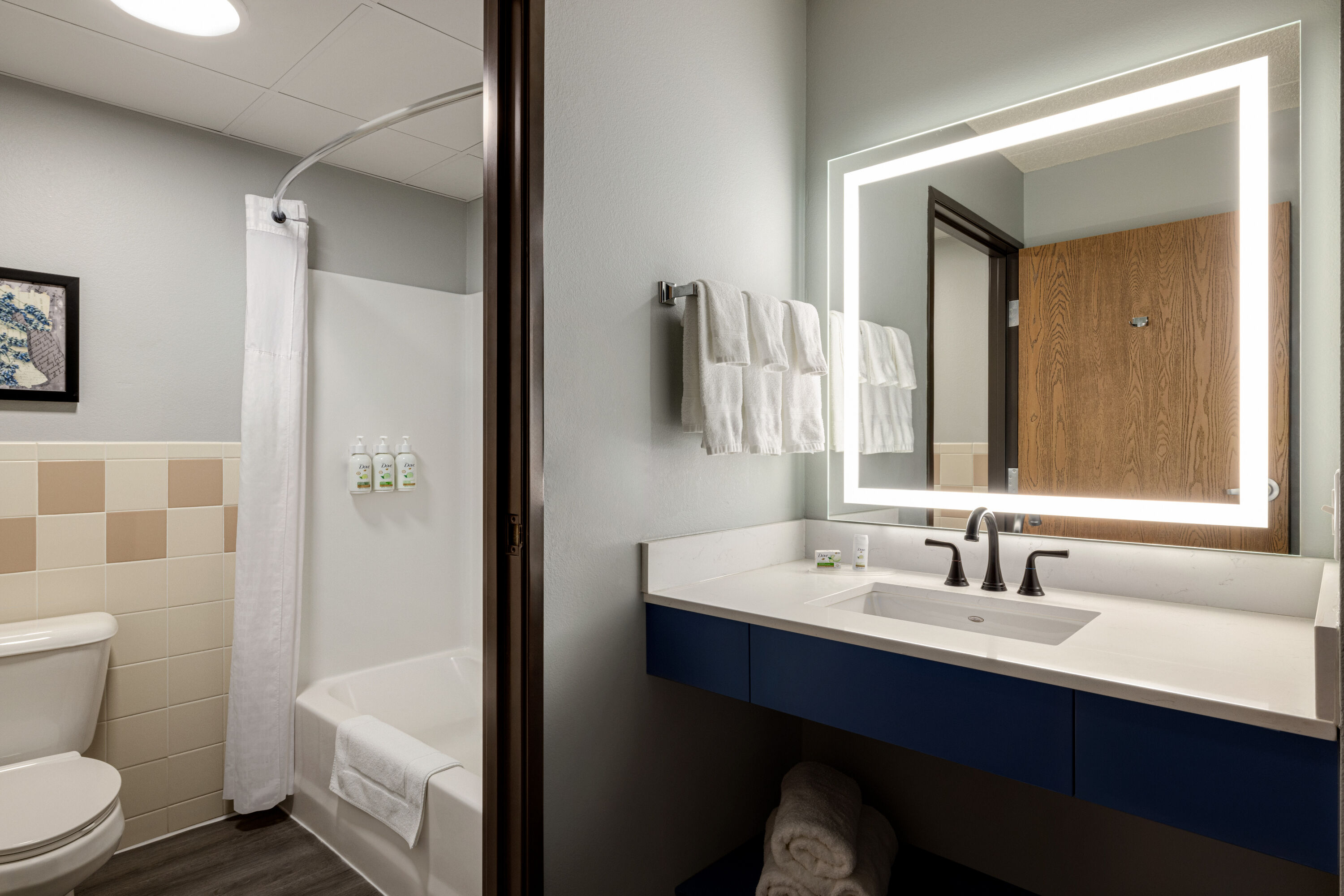 Guest room bath at the AmericInn by Wyndham Lincoln South in Lincoln, Nebraska