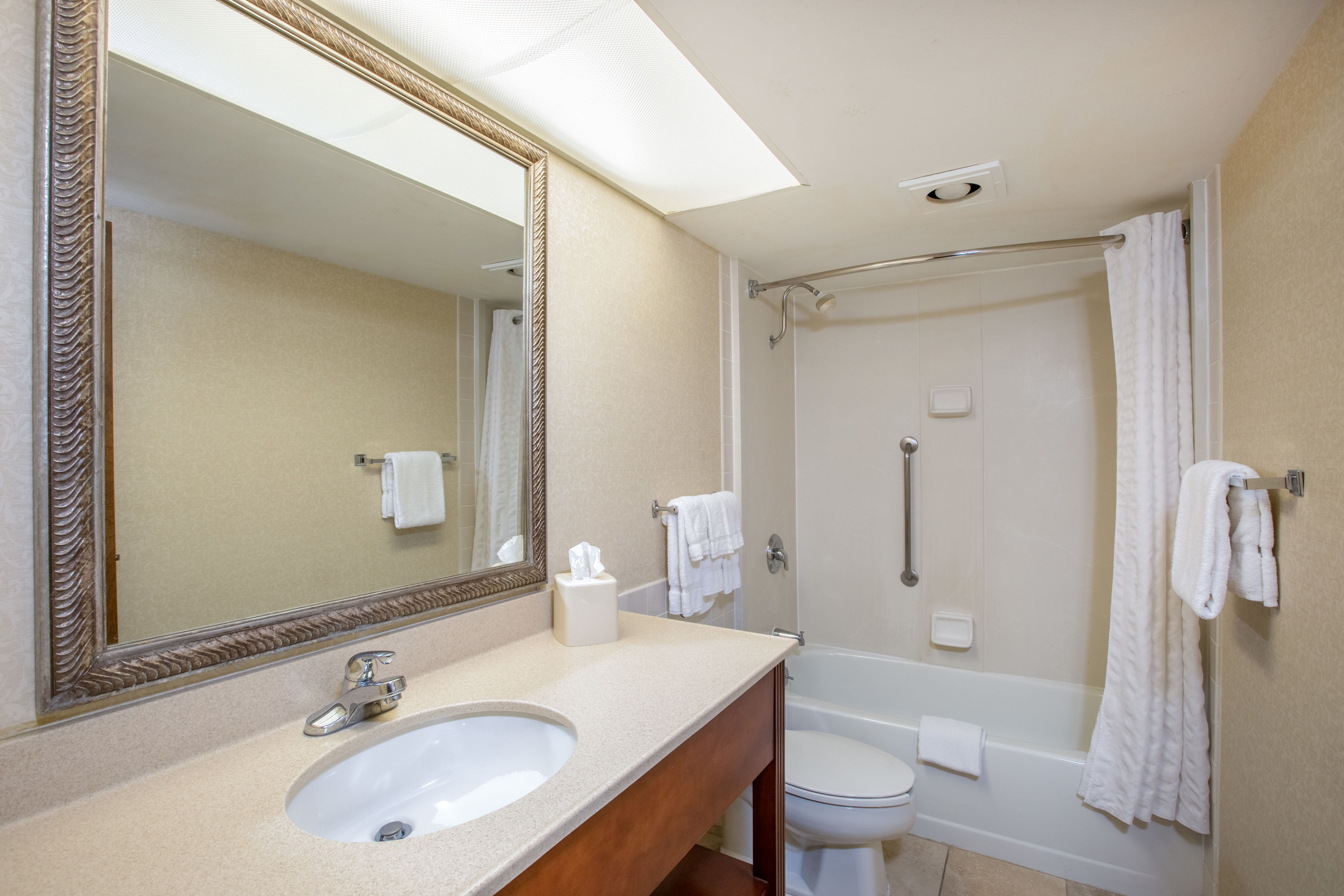 Guest room bath at the AmericInn by Wyndham Omaha in Omaha, Nebraska