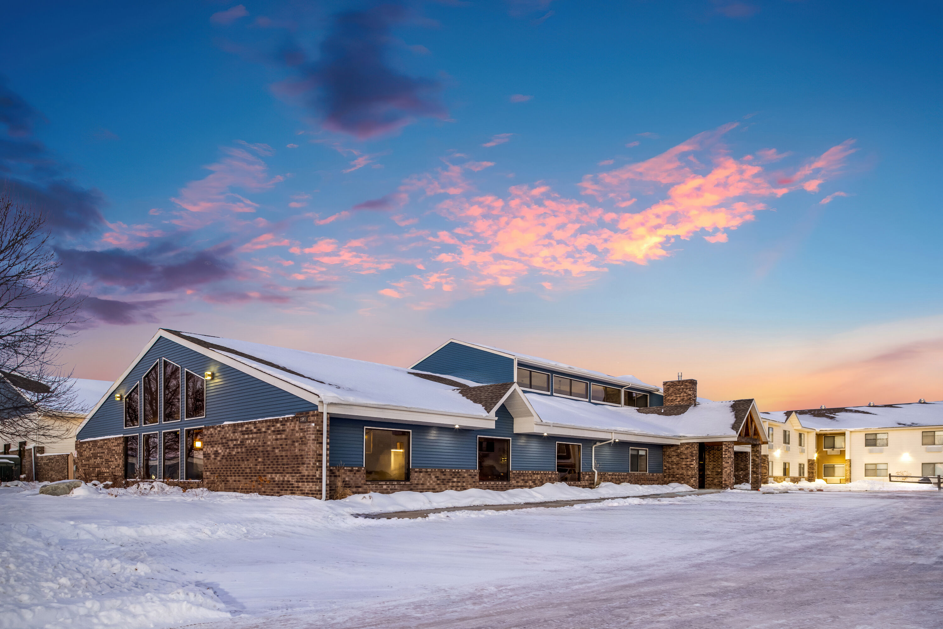Exterior Dusk Image of AmericInn by Wyndham Aberdeen Event Center hotel in Aberdeen, South Dakota