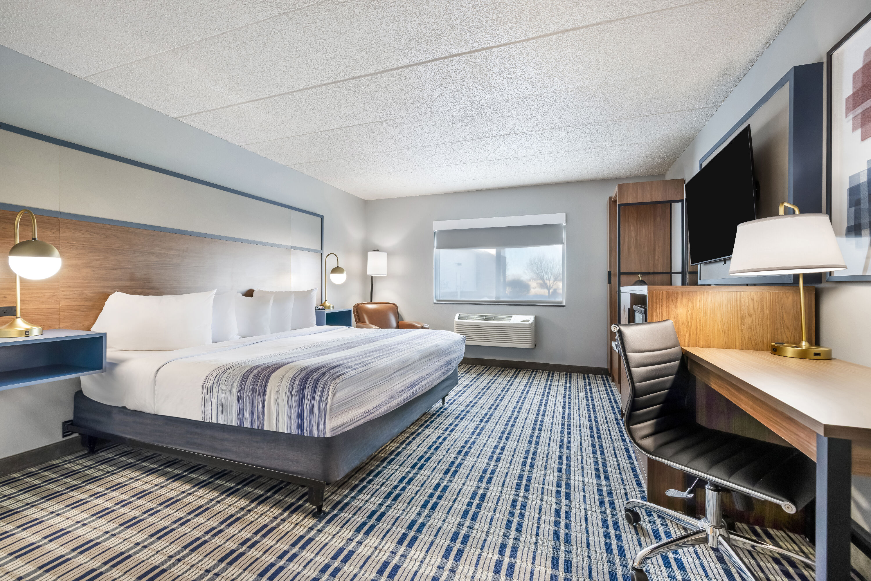 King bed guest room at the AmericInn by Wyndham Aberdeen Event Center in Aberdeen, South Dakota