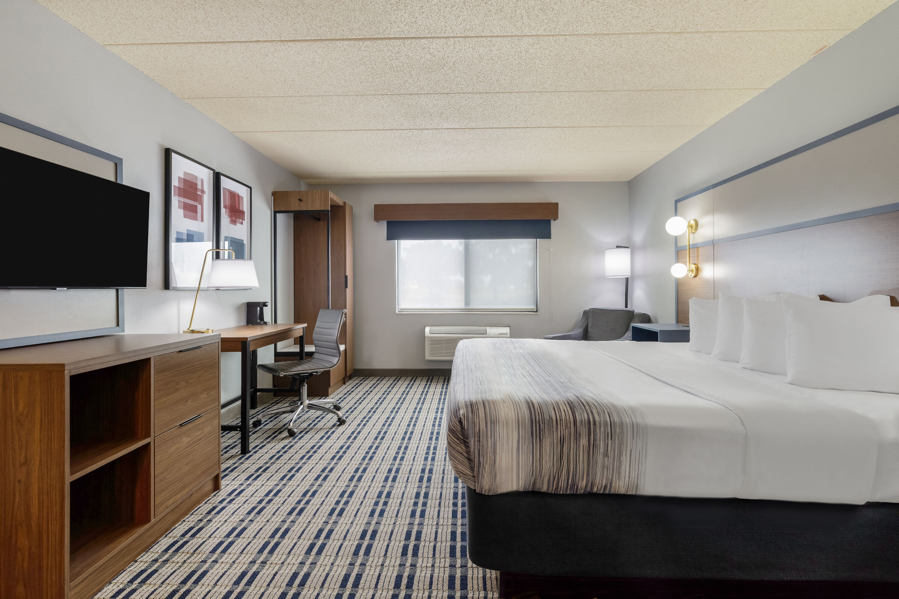 King bed guest room at the AmericInn by Wyndham Chamberlain Conference Center in Chamberlain, South Dakota