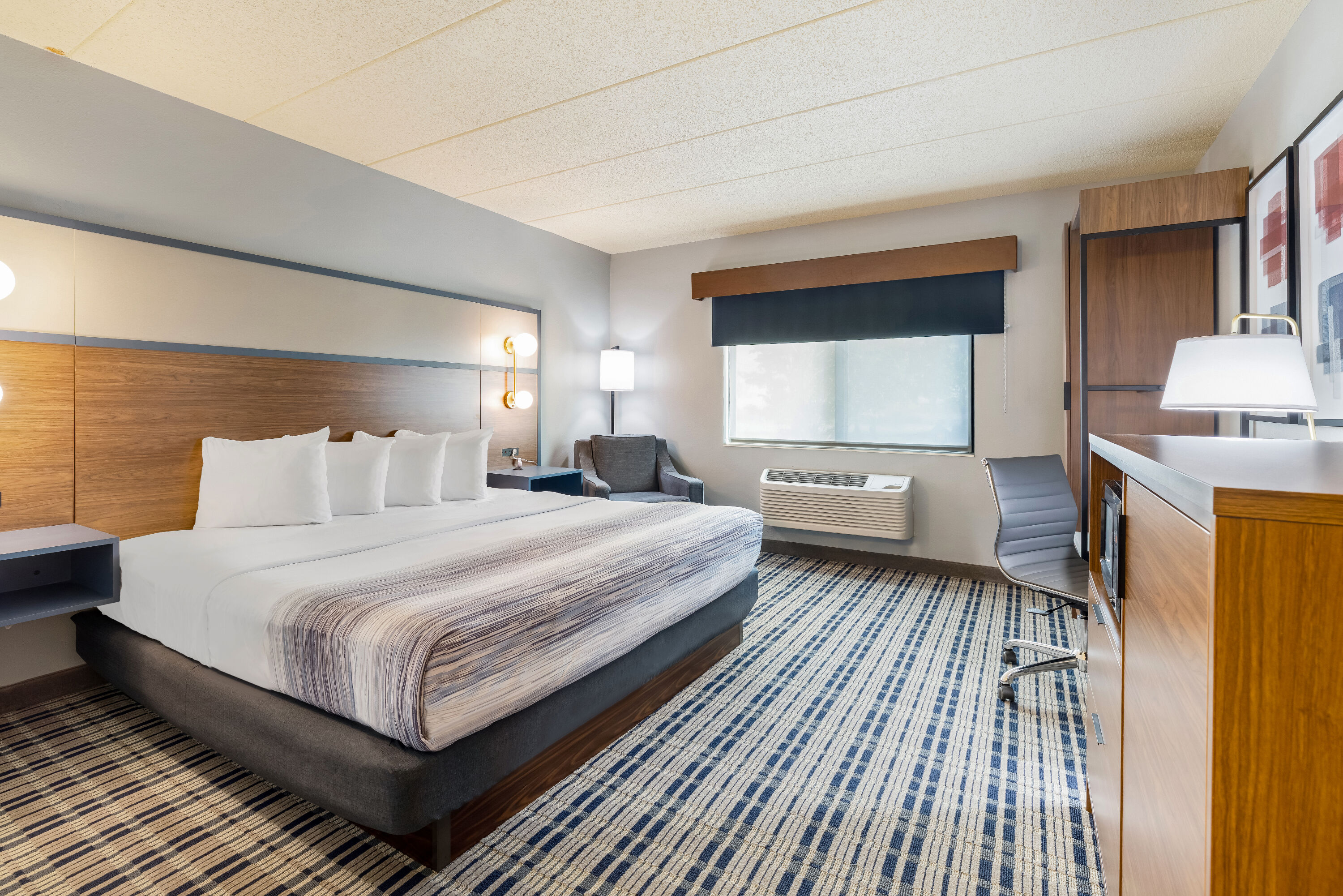 King bed guest room at the AmericInn by Wyndham Chamberlain Conference Center in Chamberlain, South Dakota