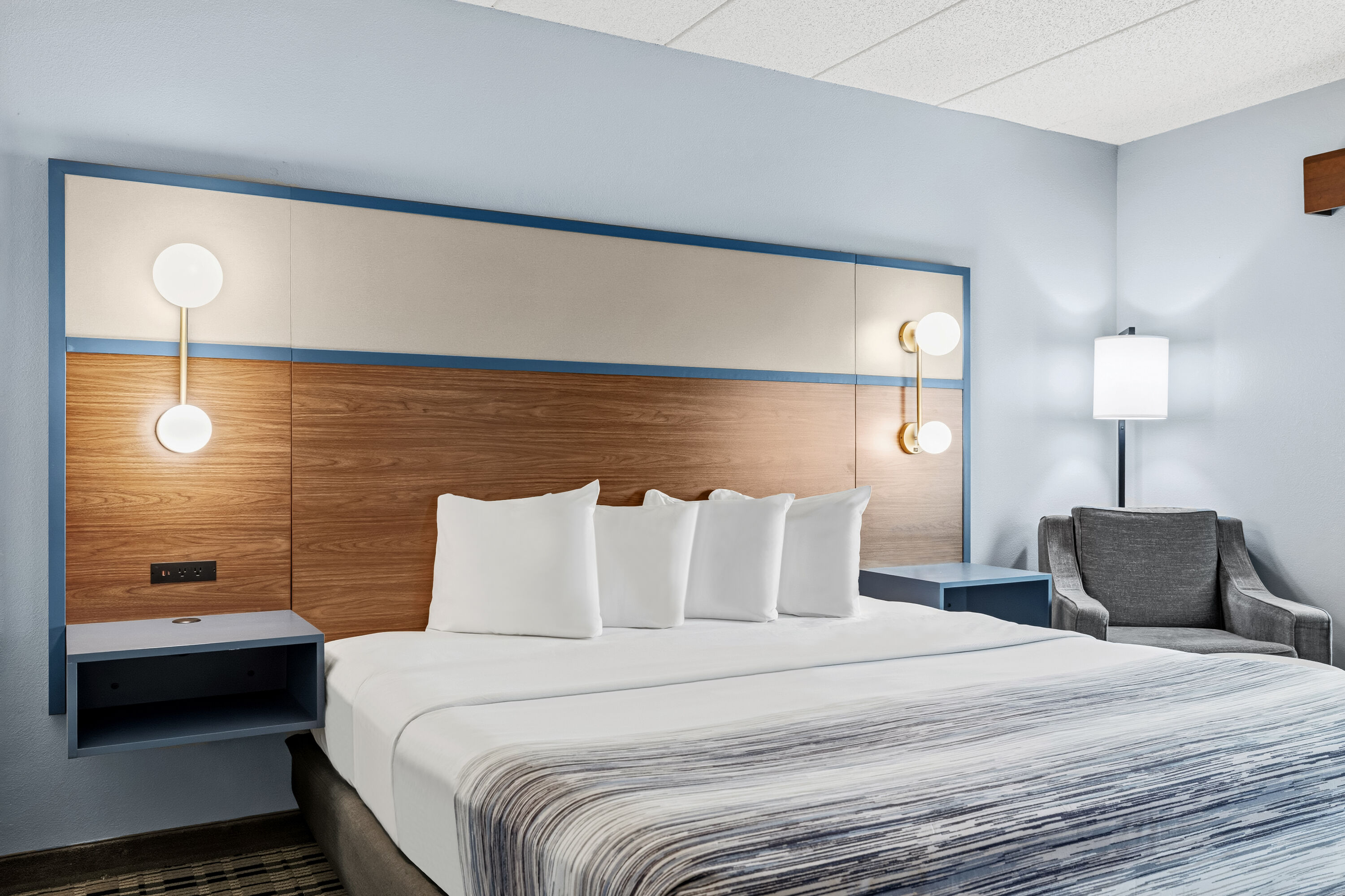 King bed guest room at the AmericInn by Wyndham Chamberlain Conference Center in Chamberlain, South Dakota