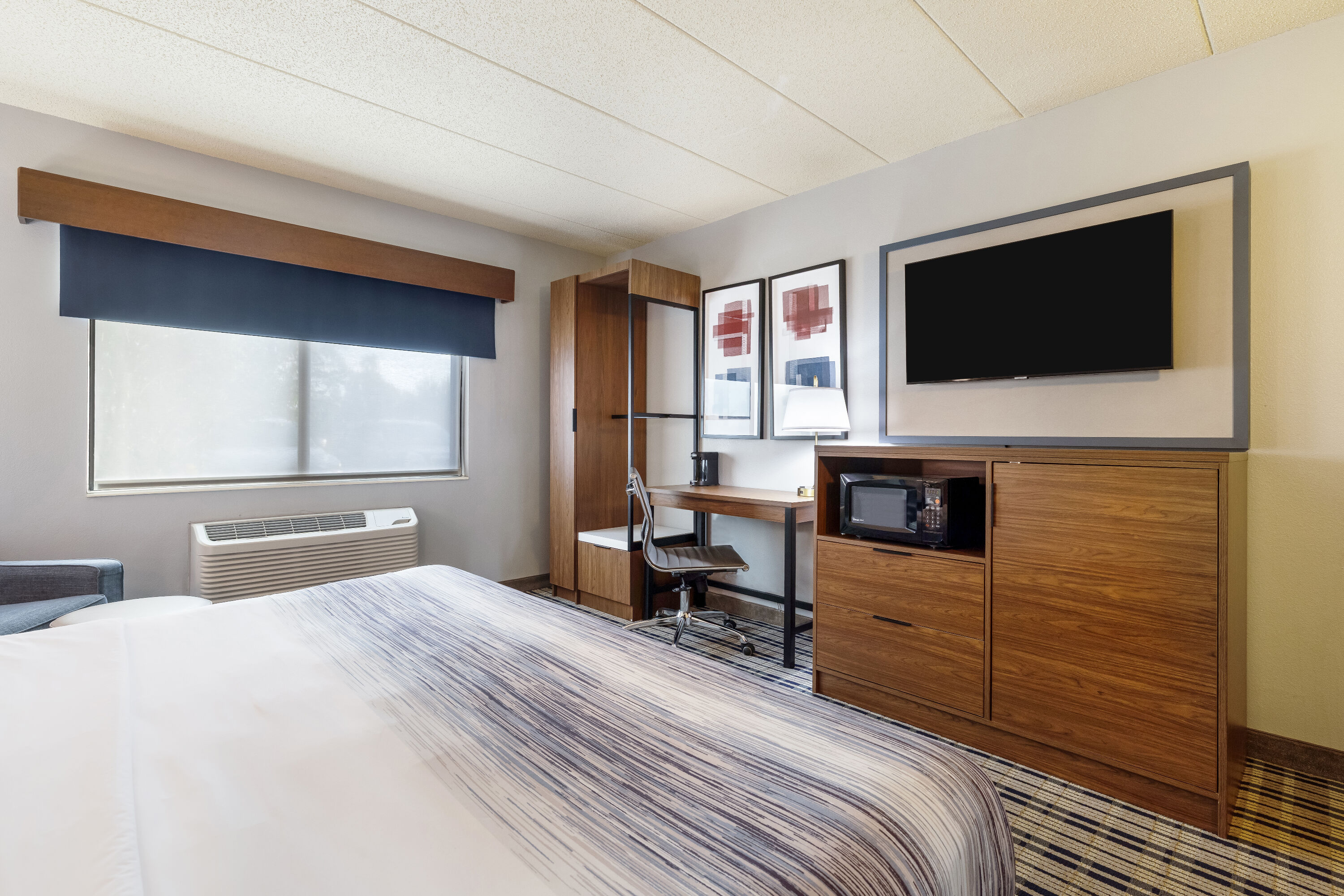 King bed guest room at the AmericInn by Wyndham Chamberlain Conference Center in Chamberlain, South Dakota