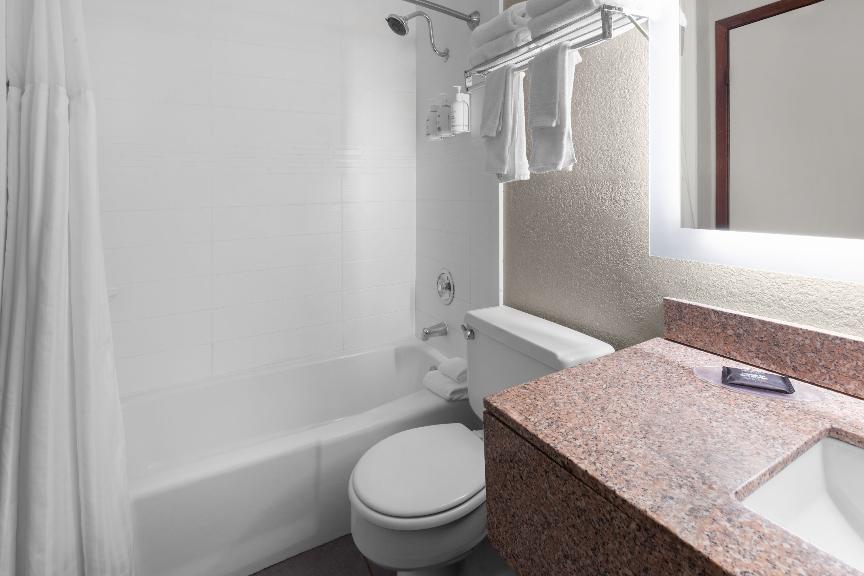 Guest room bath at the AmericInn by Wyndham Appleton Downtown in Appleton, Wisconsin