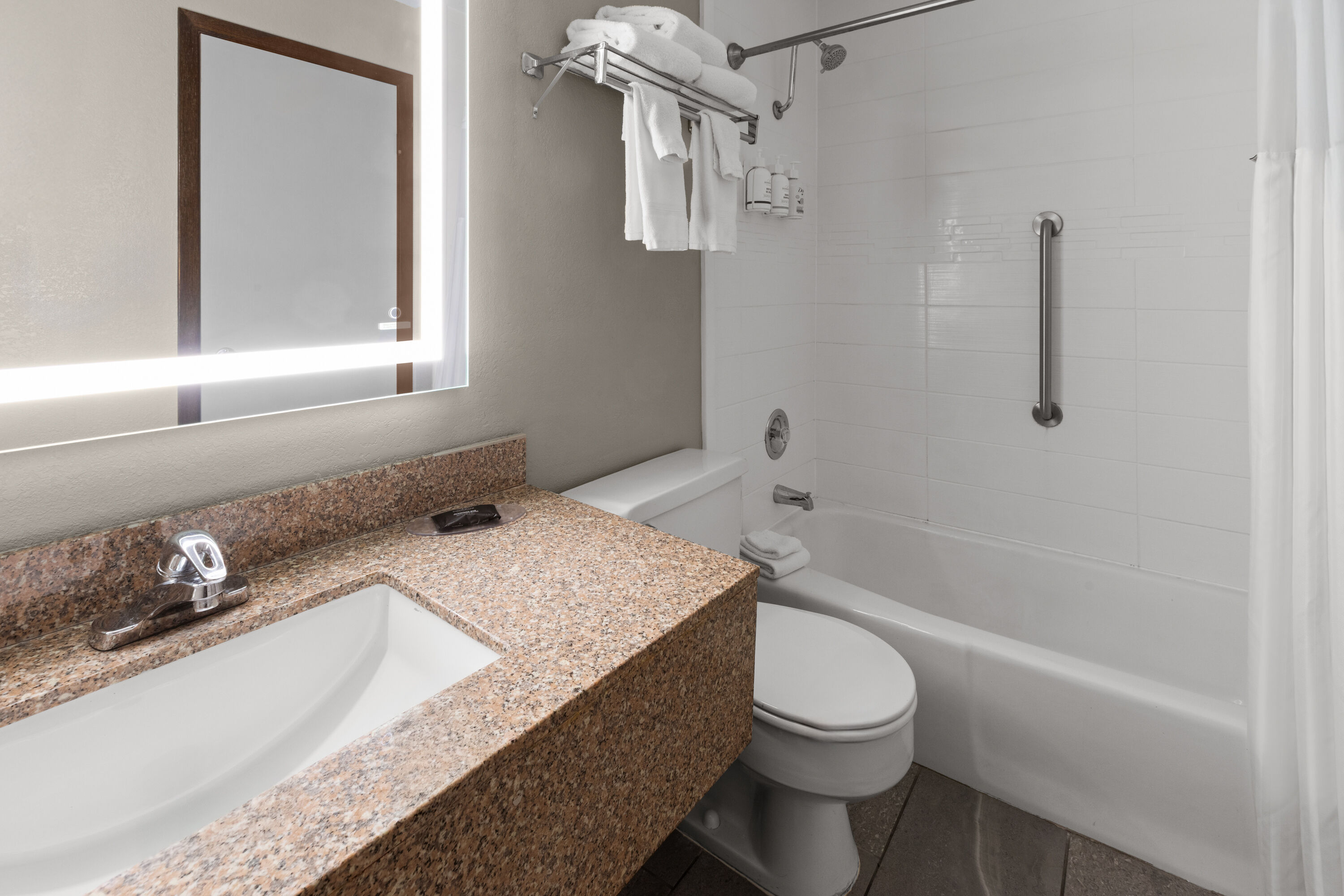 Guest room bath at the AmericInn by Wyndham Appleton Downtown in Appleton, Wisconsin