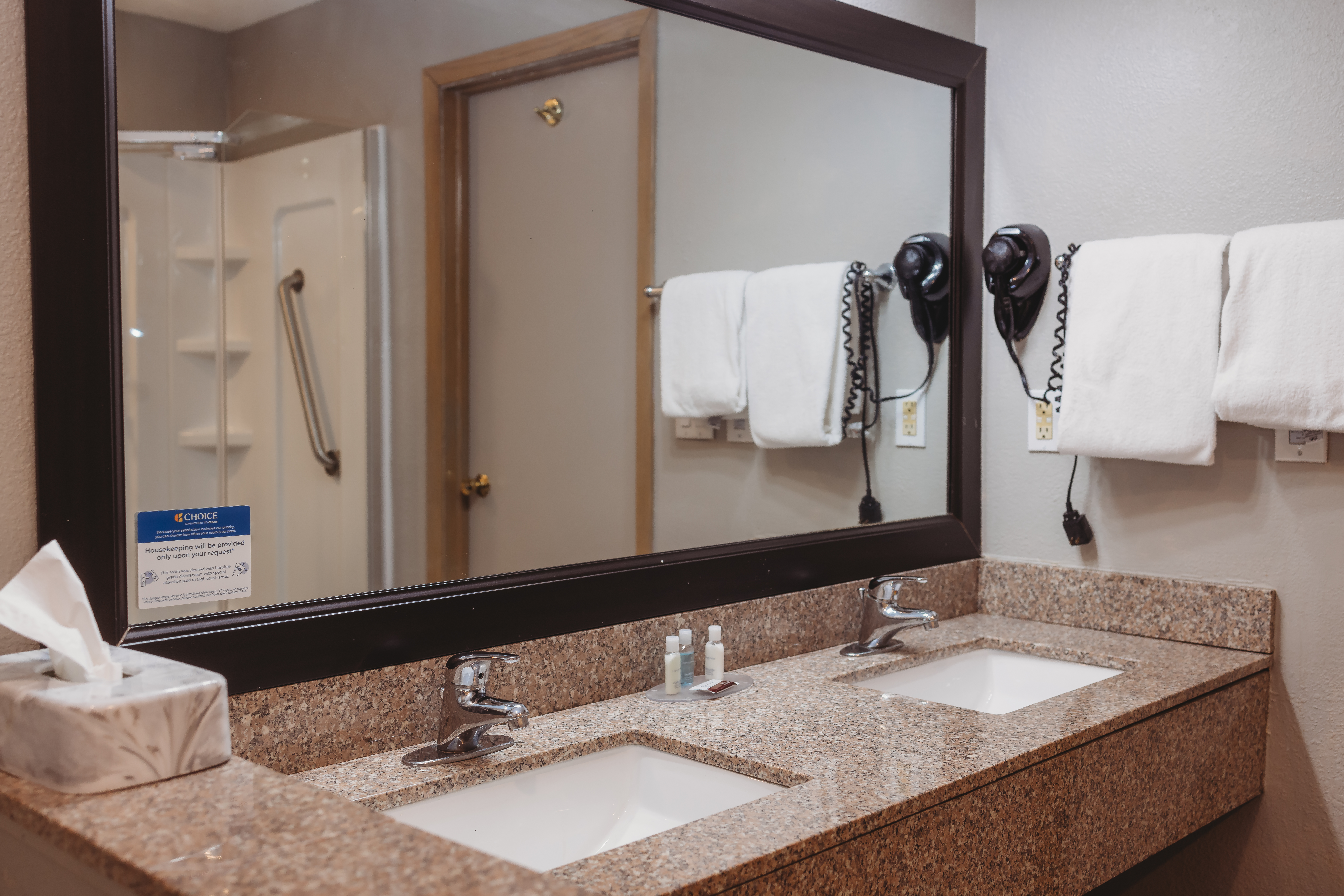 Guest room bath at the AmericInn by Wyndham Appleton Downtown in Appleton, Wisconsin