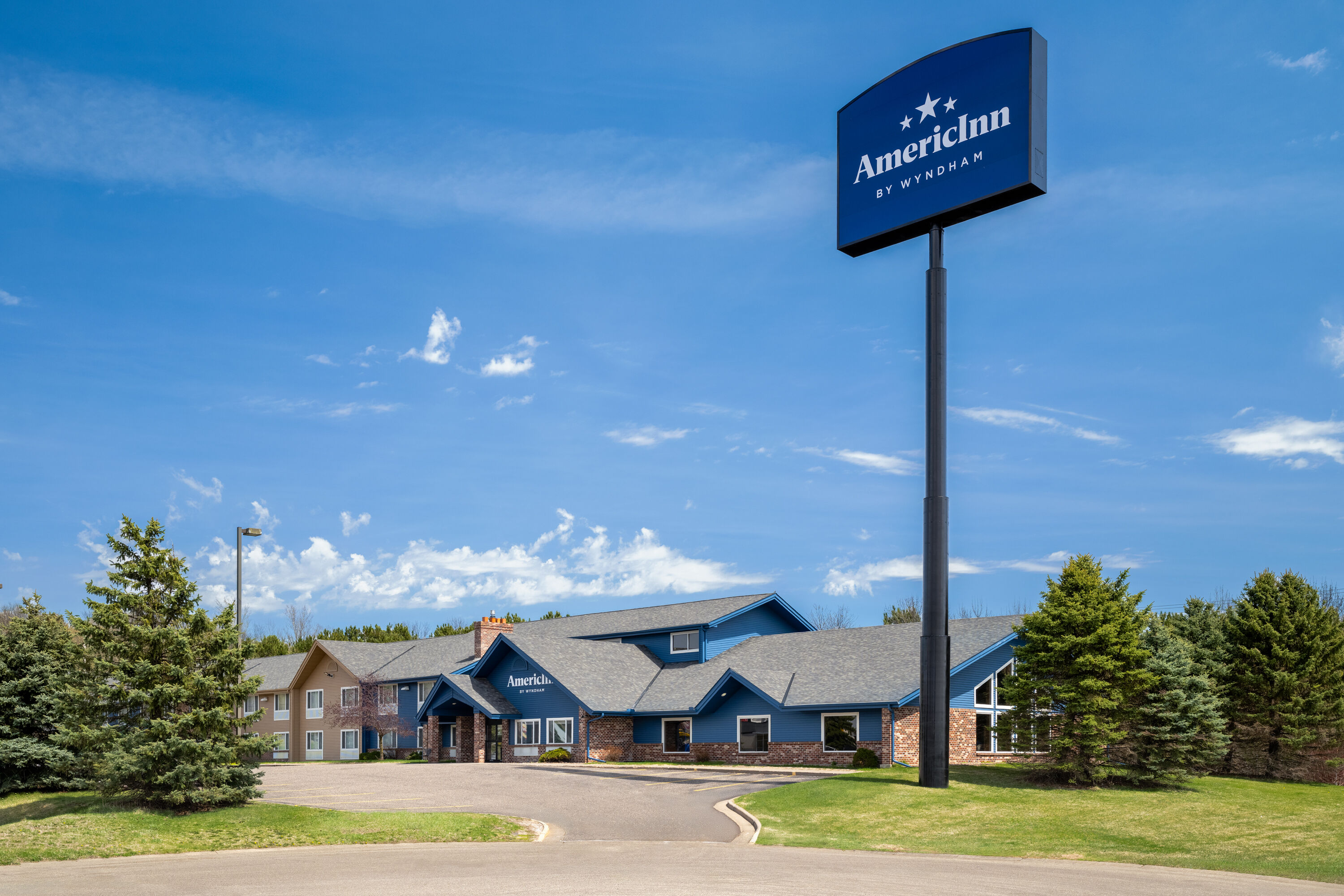 Exterior Day Image of AmericInn by Wyndham Baldwin hotel in Baldwin, Wisconsin