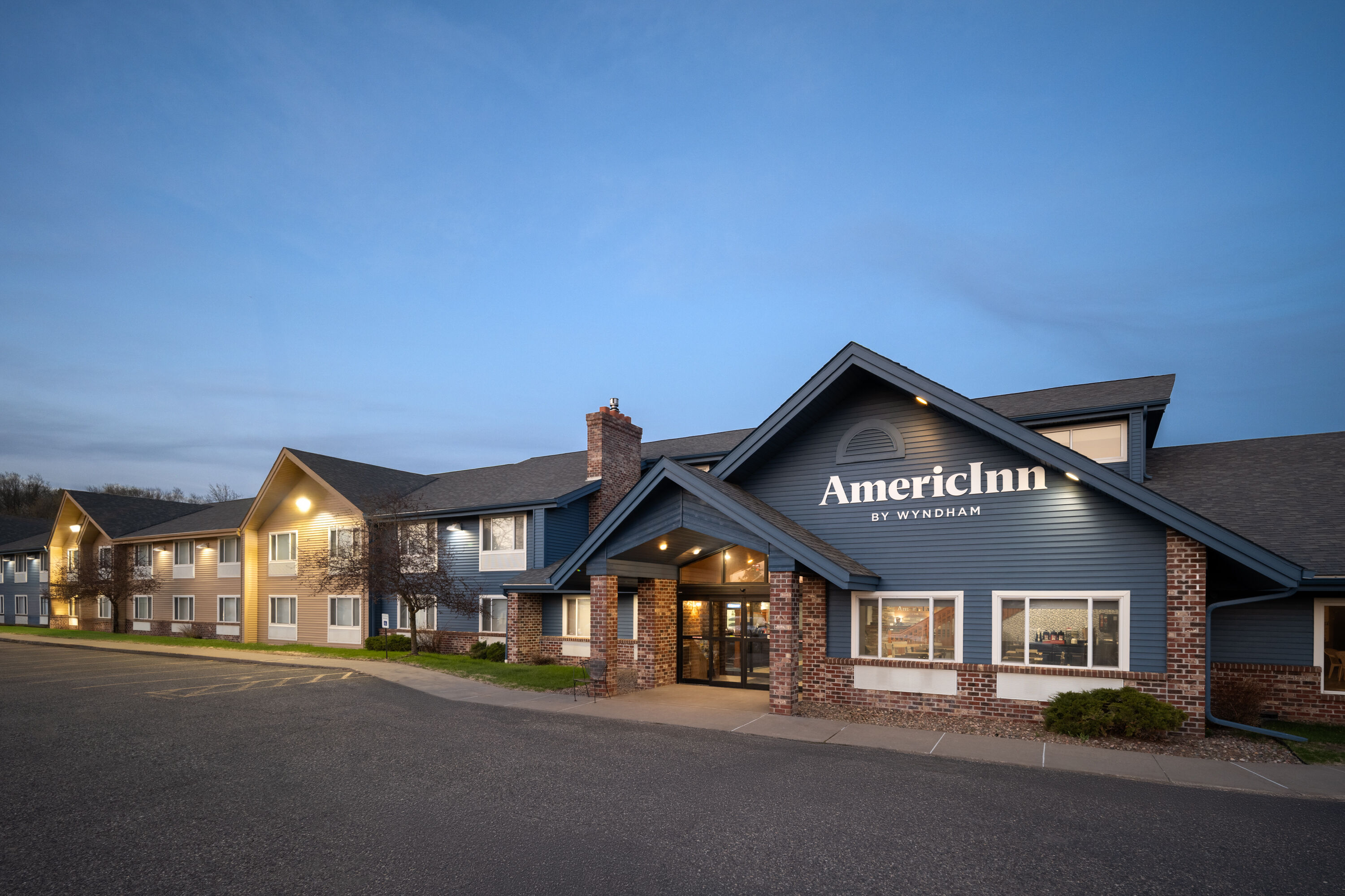 Exterior Dusk Image of AmericInn by Wyndham Baldwin hotel in Baldwin, Wisconsin