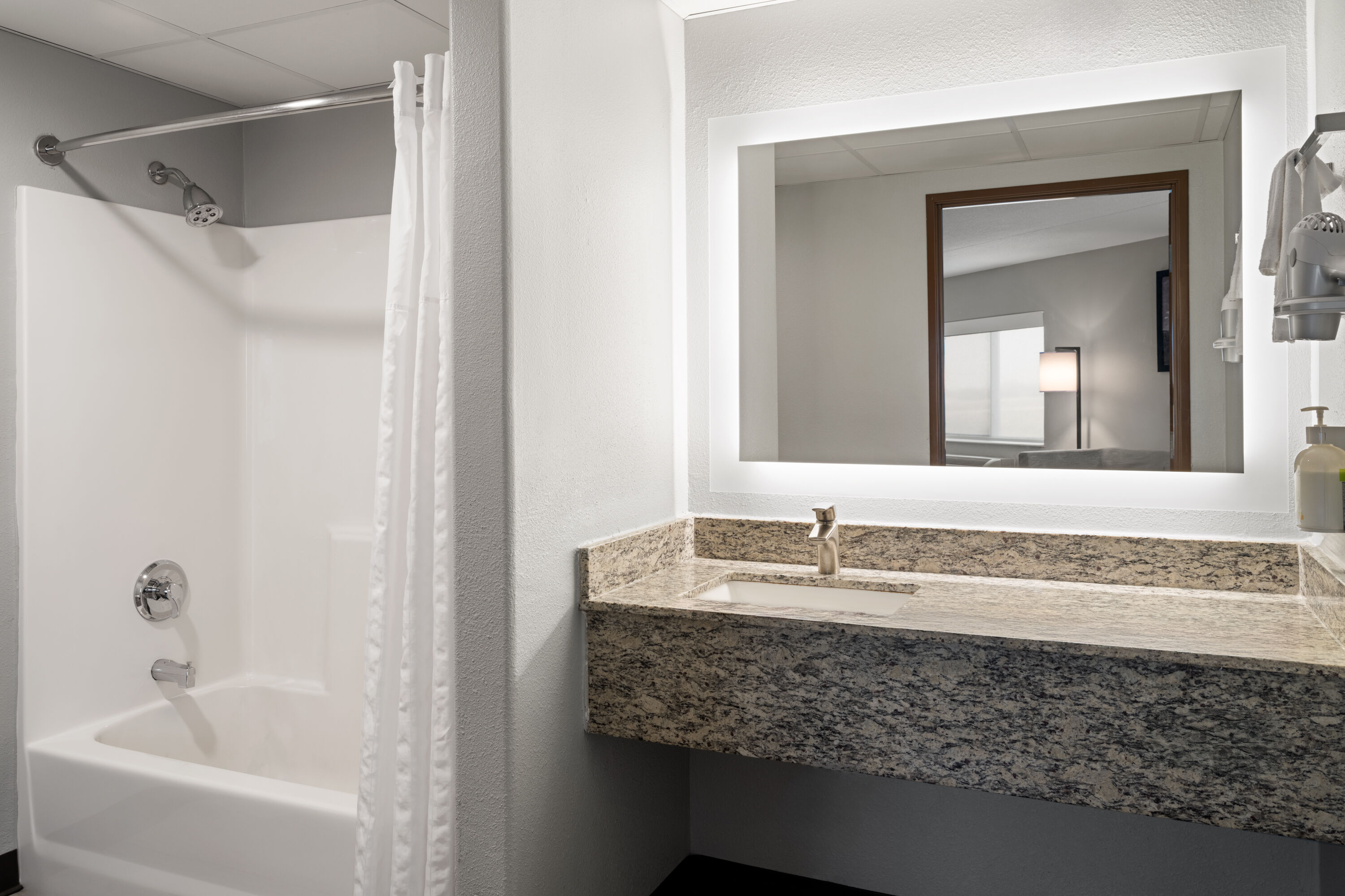 Guest room bath at the AmericInn by Wyndham Beaver Dam in Beaver Dam, Wisconsin