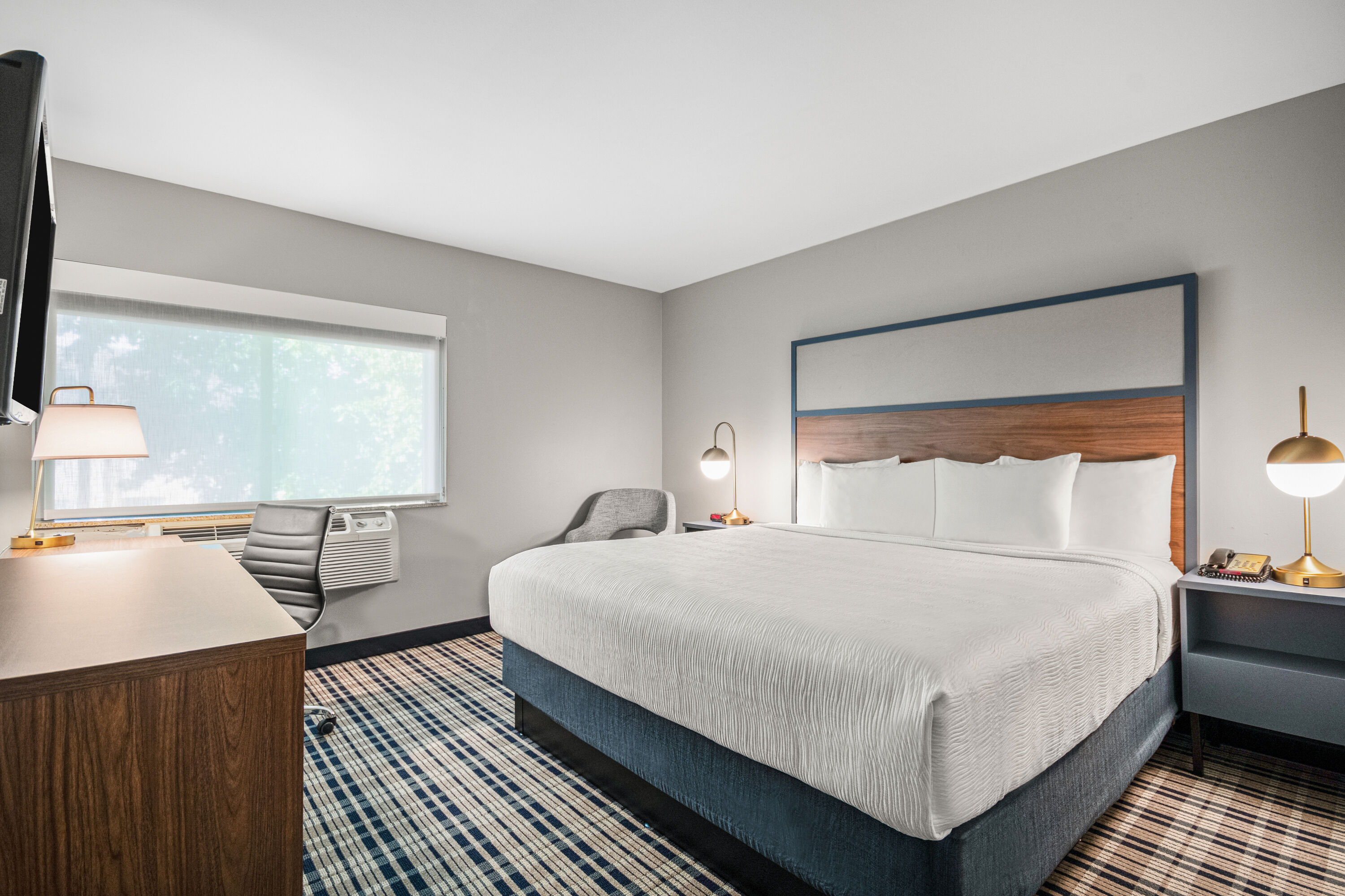 King bed guest room at the AmericInn by Wyndham Beloit in Beloit, Wisconsin