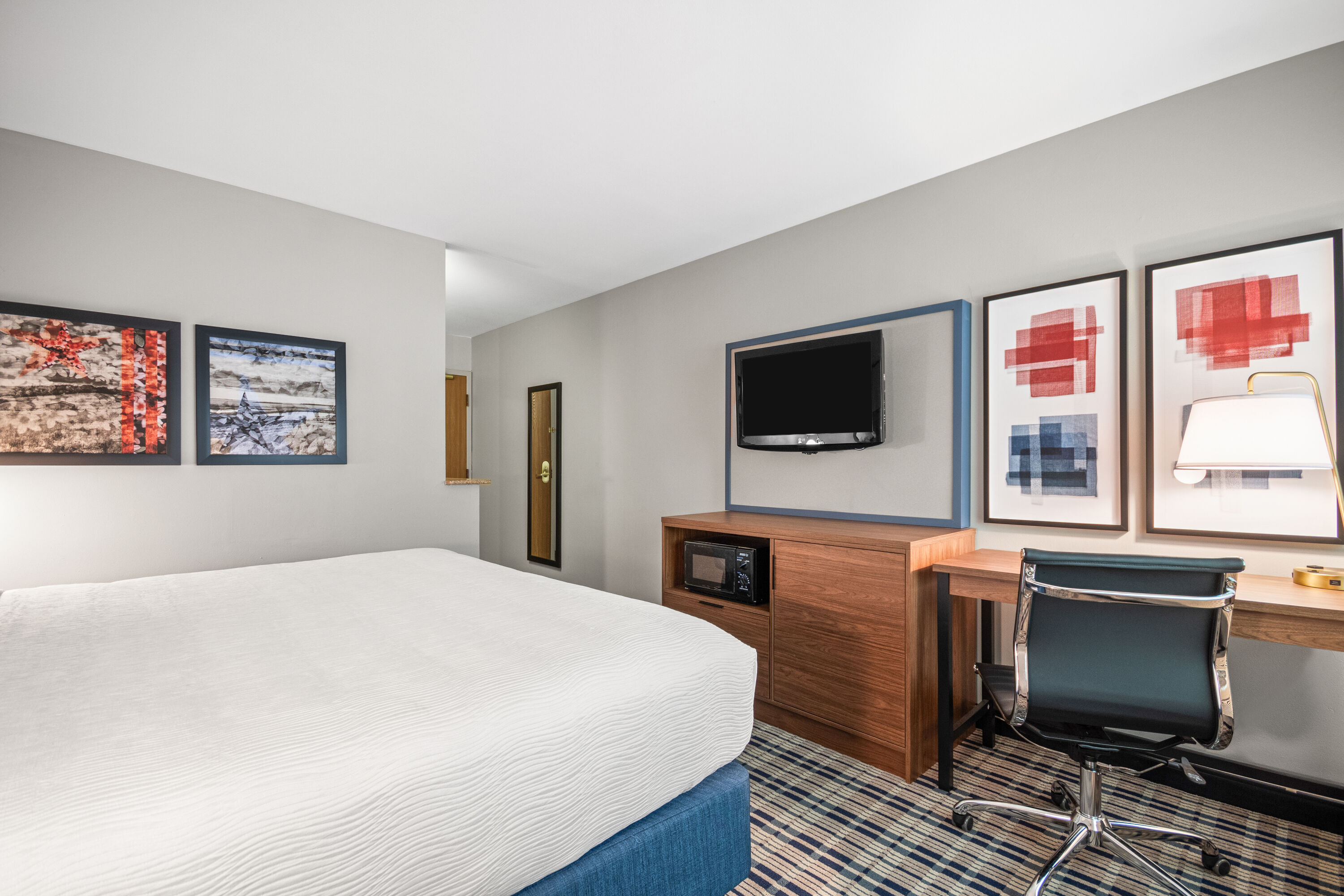 King bed guest room at the AmericInn by Wyndham Beloit in Beloit, Wisconsin