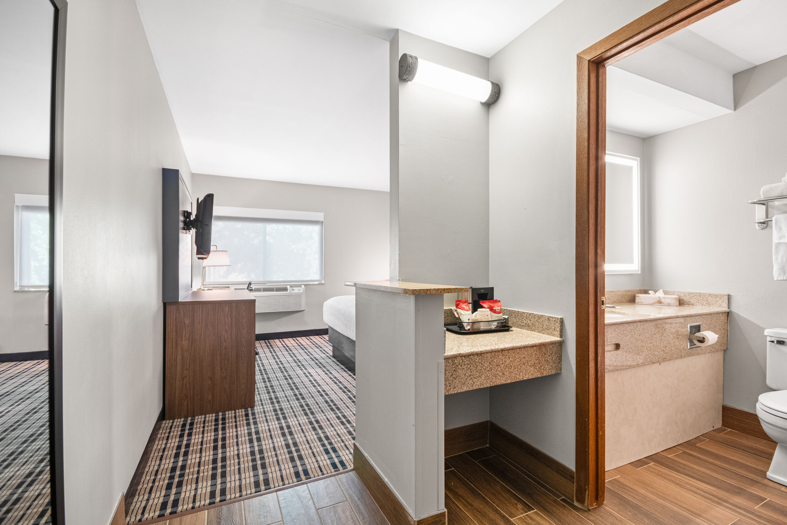 King bed guest room at the AmericInn by Wyndham Beloit in Beloit, Wisconsin