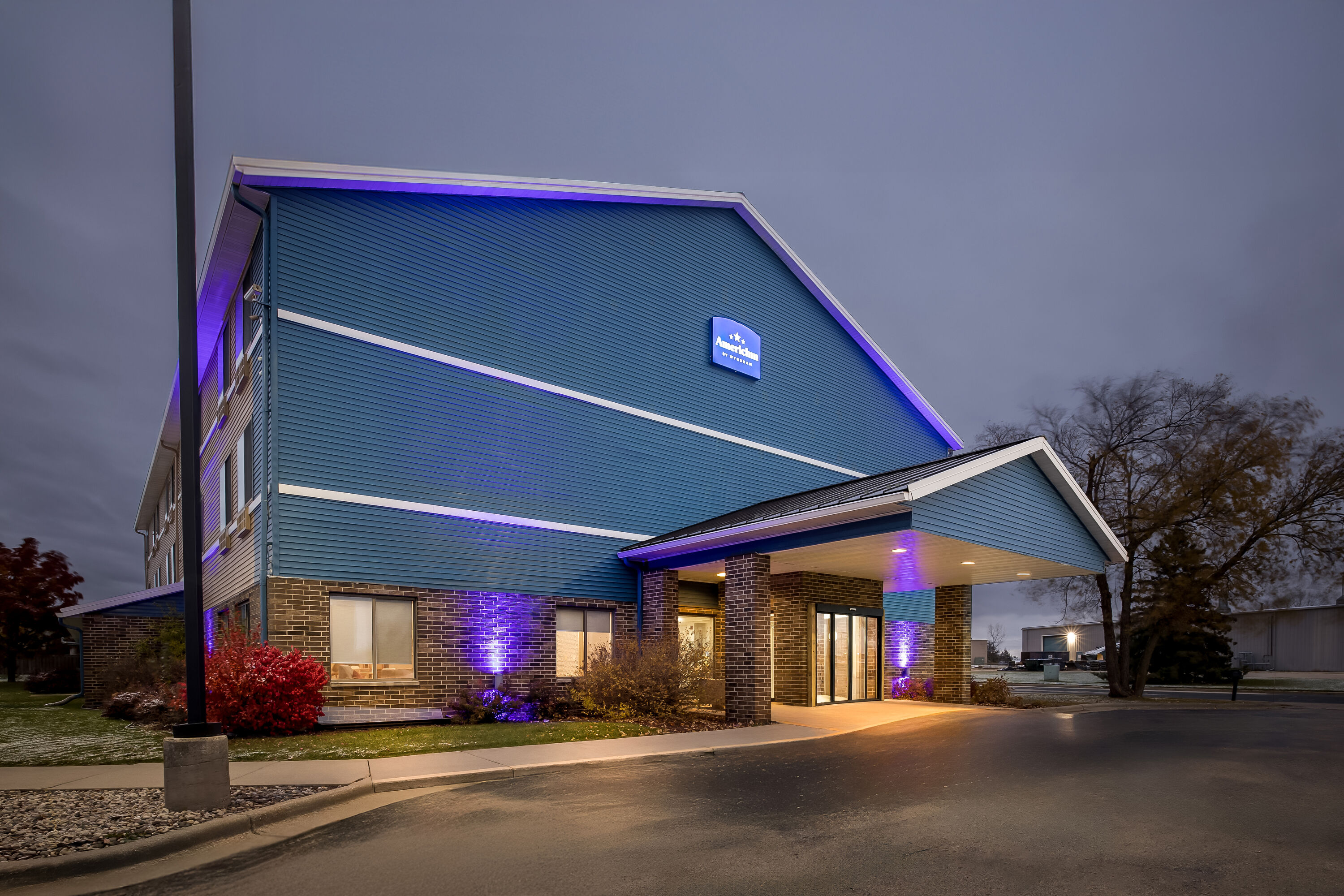 Exterior Night Image of AmericInn by Wyndham Columbus Wisconsin hotel in Columbus, Wisconsin